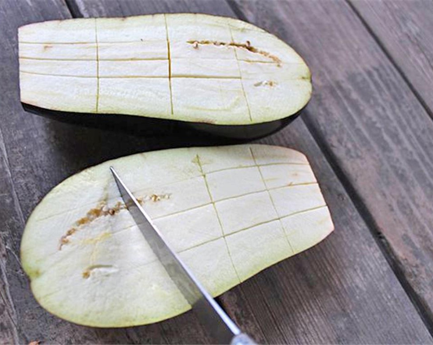 step 3 Wash Eggplant (1), cut off the top and slice lengthwise. Make slices through the flesh but not the skin with a knife (three in every direction).