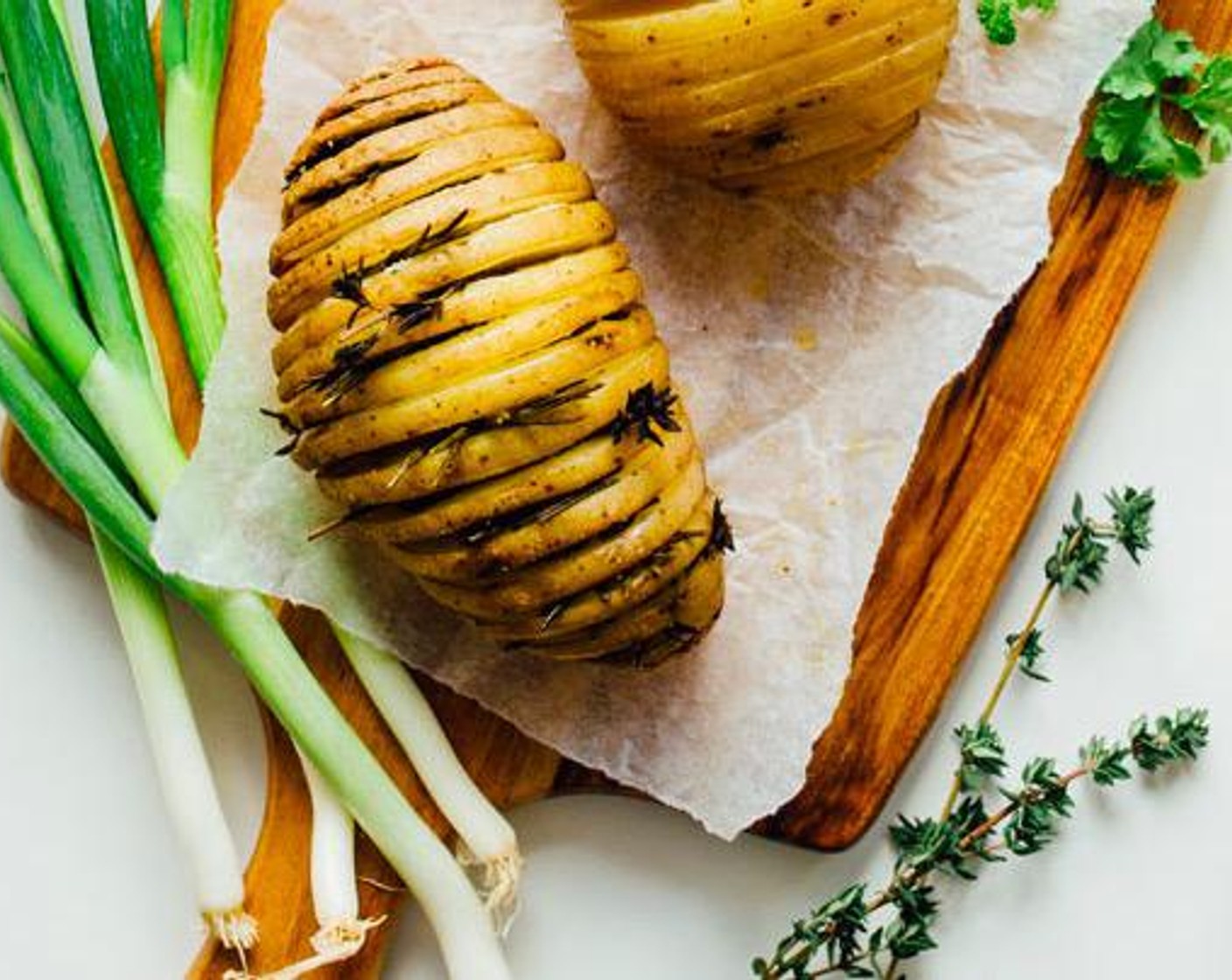 step 2 Stuff Fresh Thyme (6 sprigs) and Fresh Rosemary (4 sprigs) between potato slices. Set in a parchment paper-lined slow cooker and brush with Olive Oil (1 tsp). Cook on high for 3 hours, or until potatoes are soft.