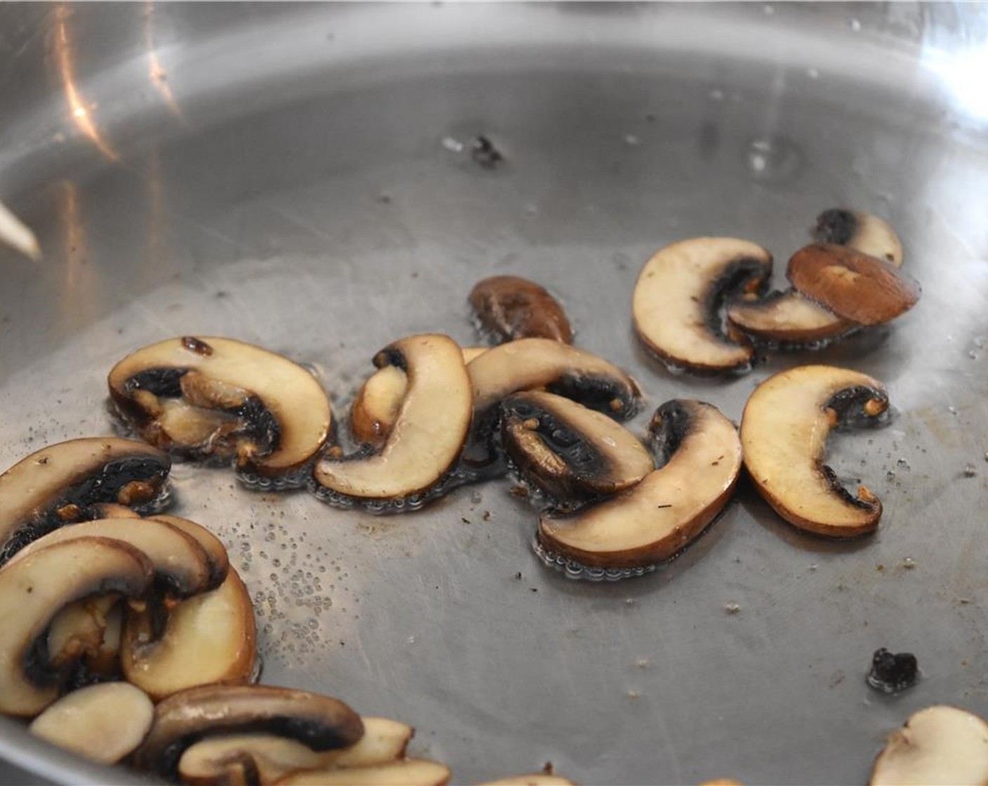 step 4 Heat the pan over medium heat. Place your Vegetable Oil (3 Tbsp) in the pan then add the mushrooms and cook until they're 75% done, about 4 to 5 minutes (how they look in the photo).