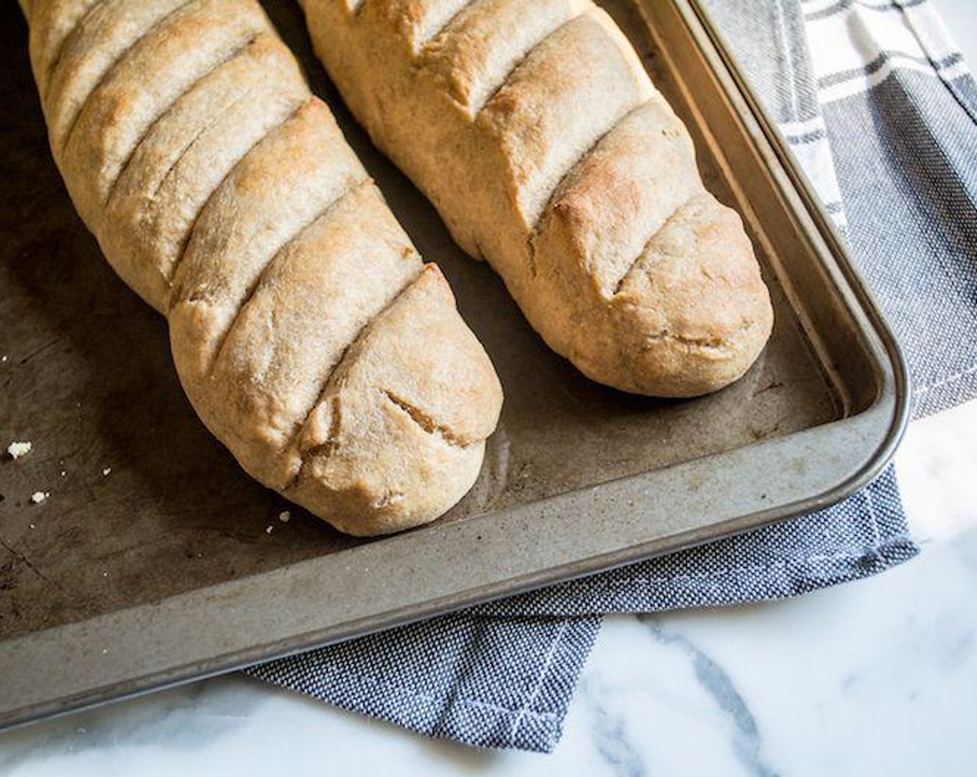 step 6 For an authentic look, use a serrated knife to gently make slash down the length of each baguette or diagonal lines across the top as shown in pictures.