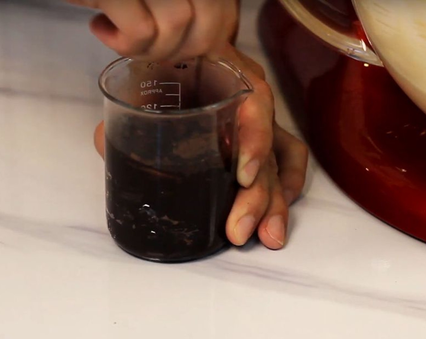 step 6 In a small bowl, mix Unsweetened Cocoa Powder (3 Tbsp), Activated Black Charcoal (1/2 Tbsp), and a couple of splashes of hot water until you have a paste while things are mixing.