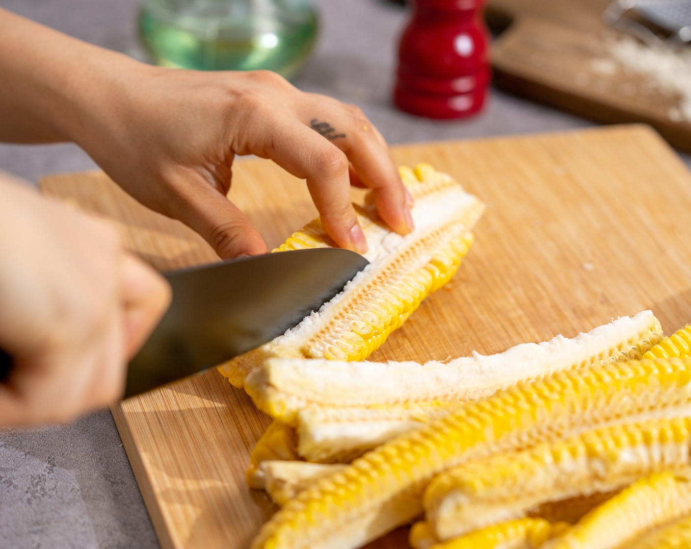 step 3 Use a sharp knife to cut Corn (4 ears) vertically into quarters like riblets.