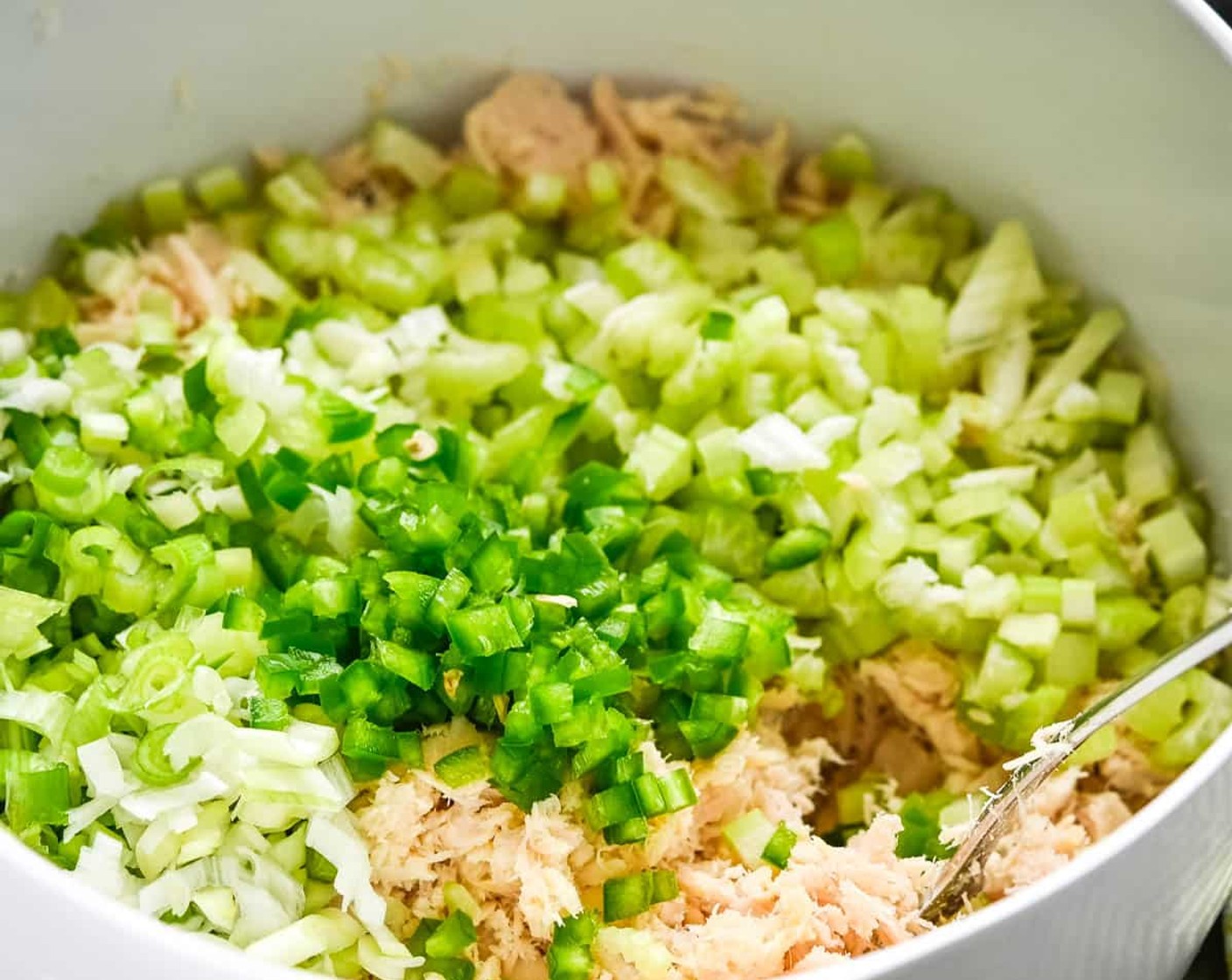 step 1 Add the Canned Tuna in Water (4 cans) to a medium bowl and break it apart with a fork. Add the chopped Celery (2 stalks), Scallion (1 bunch), and Jalapeño Pepper (1) to the tuna and toss to combine.