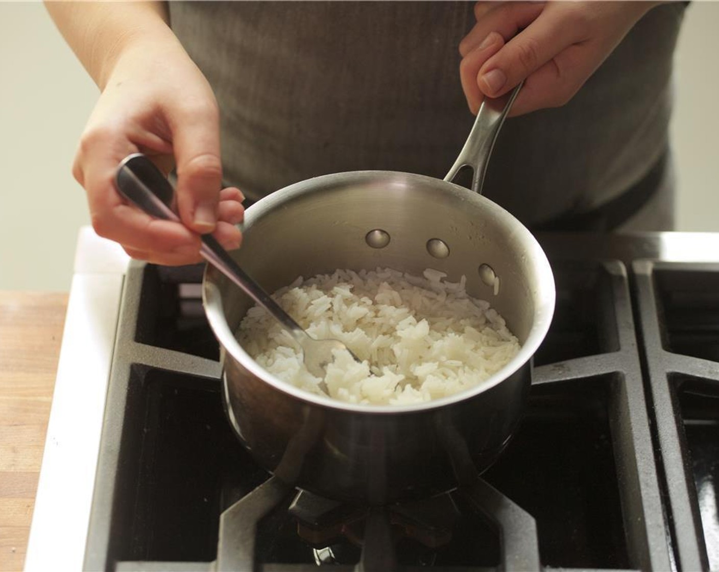 step 5 Meanwhile, in a medium saucepan, add one cup of water and the rice and bring to a boil over medium high heat. Stir once, then cover and reduce heat to low and simmer for ten minutes. Remove from heat, fluff rice, and hold until plating.