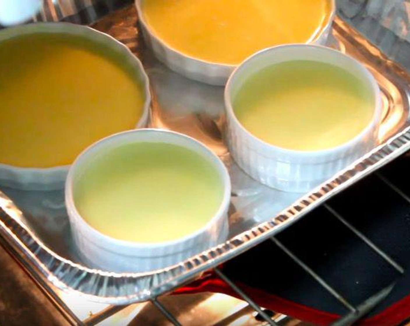 step 4 Arrange ramekins in a baking pan filled halfway with hot water. Divide Nutella® (4 Tbsp) evenly into the bottom of each ramekin. Pour the cream mixture over top.