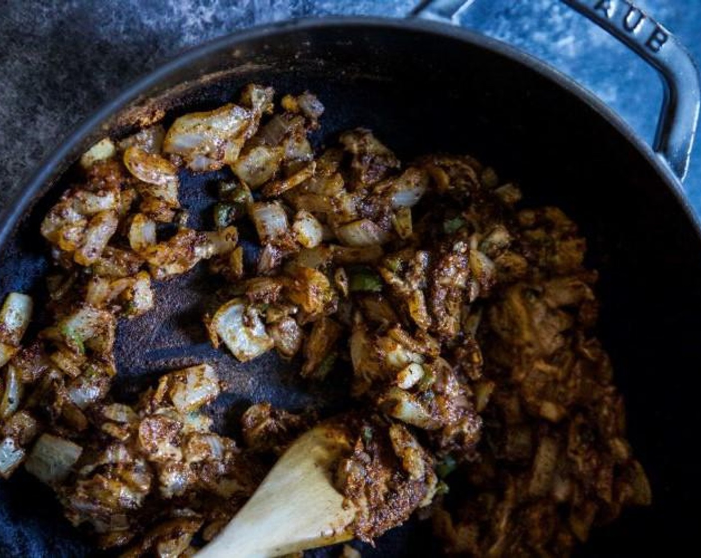 step 2 In the same Dutch oven there should be enough renderings from the ground beef. If not, add Olive Oil (1 Tbsp). Over medium-high heat add the Yellow Onion (1 cup), Jalapeño Pepper (1) and Garlic (2 cloves). Stir to combine and saute for a few minutes.