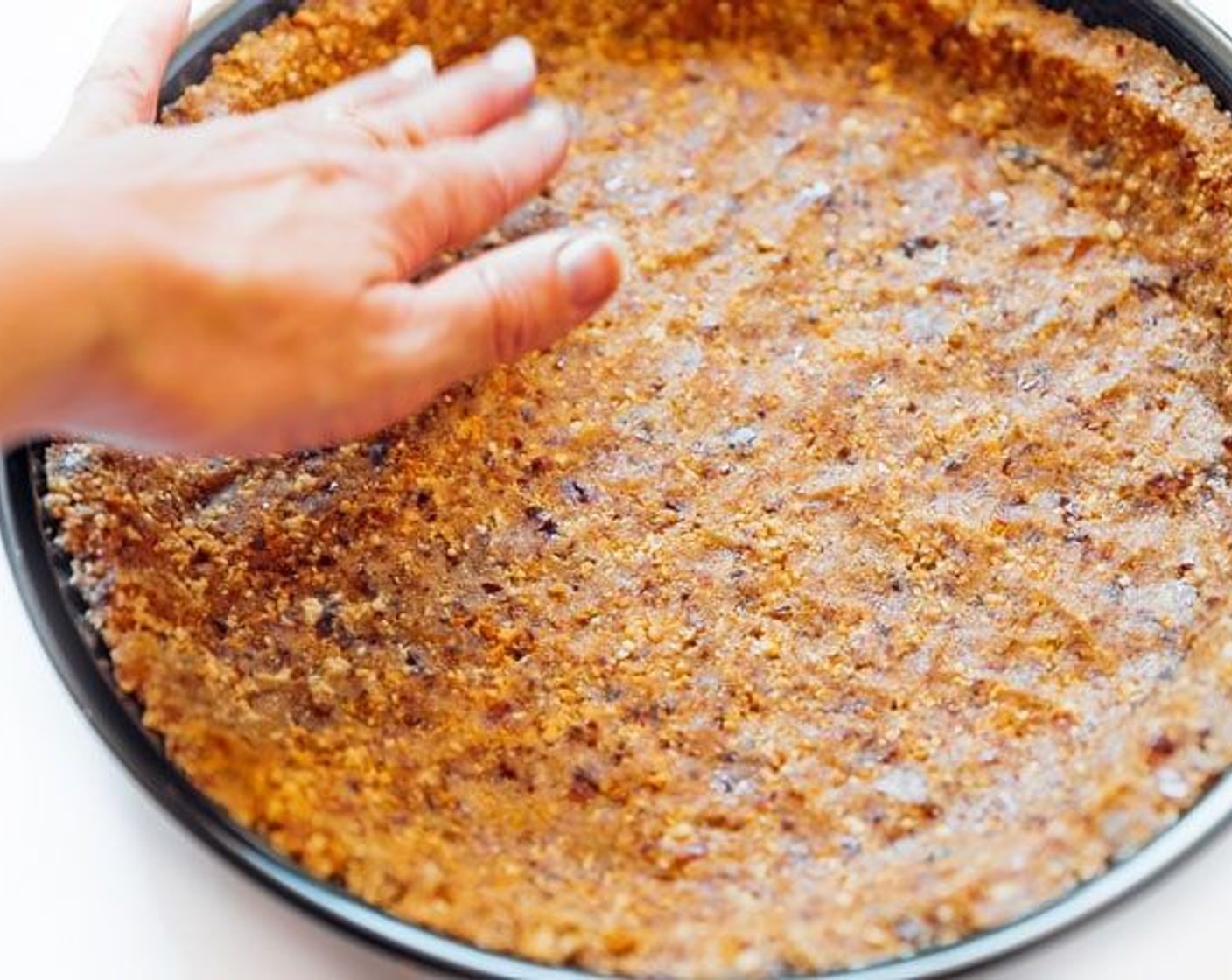 step 2 Lightly grease an 8 or 9 inch pie pan, then press crust mixture into the bottom and up the sides.