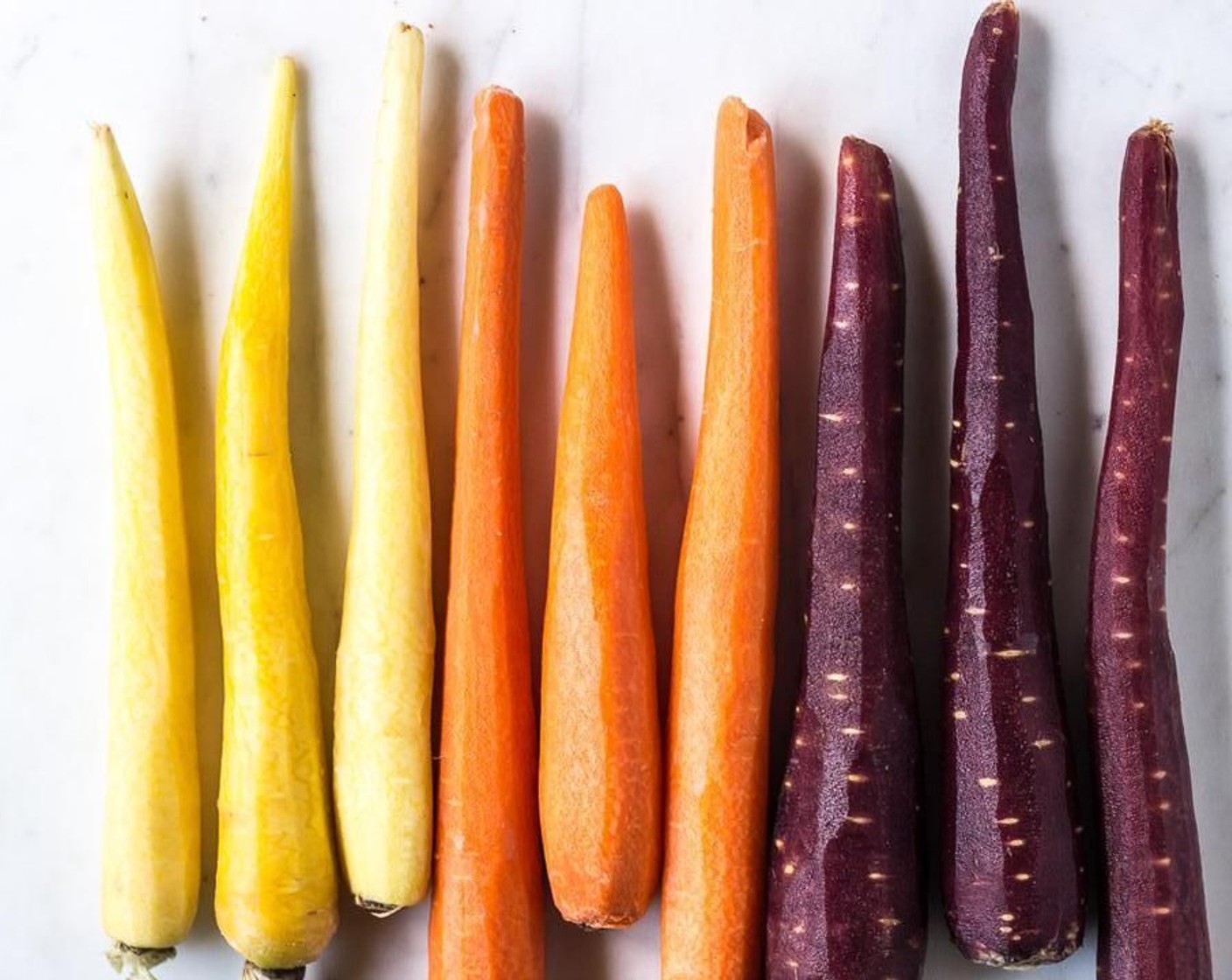 step 2 Use a vegetable peeler, mandoline, or spiralizer to slice the Carrots (10) into long, thin strips.