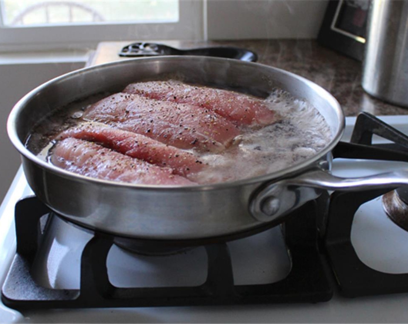 step 3 Heat Vegetable Stock (2 cups) and when it's boiling, add the Swordfish Fillet (1) with its skin removed, Salt (1 pinch), Ground Black Pepper (1 pinch) and Fennel Pollen (1 pinch). Braise for about 10-20 minutes, depending on the thickness of the fish.