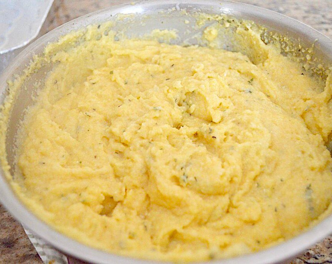 step 3 Then slowly pour in the Polenta (1 cup) while you continue to whisk. Keep whisking while the polenta cooks for about 3 minutes. Once it is cooked, remove the pot from the heat and stir in the sauce and Asiago Cheese (1/4 cup).