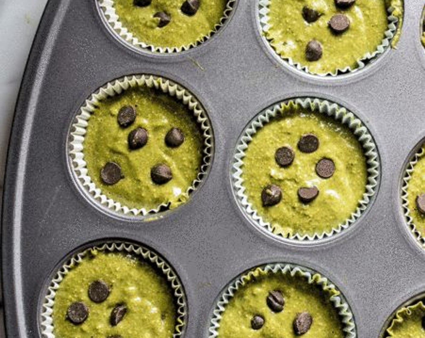 step 7 Stir in Semi-Sweet Chocolate Chips (1/2 cup), reserving a few for the tops, then divide evenly among 12 lined muffins.