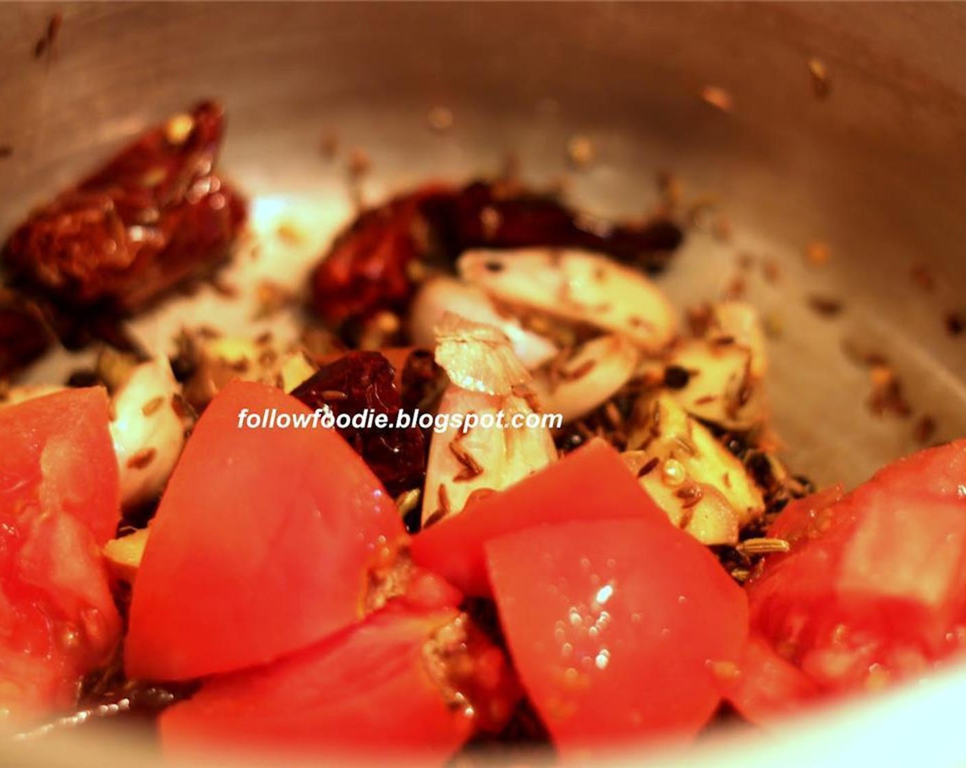 step 4 In a pressure cooker, add Oil (2 Tbsp) Fry the Red Chili Peppers (15), Cumin Seeds (1 Tbsp), Peppercorns (1/2 Tbsp), Fennel Seeds (1 tsp), ginger, chopped tomatoes and Garlic (8 cloves). Cook until the tomatoes are mushy.