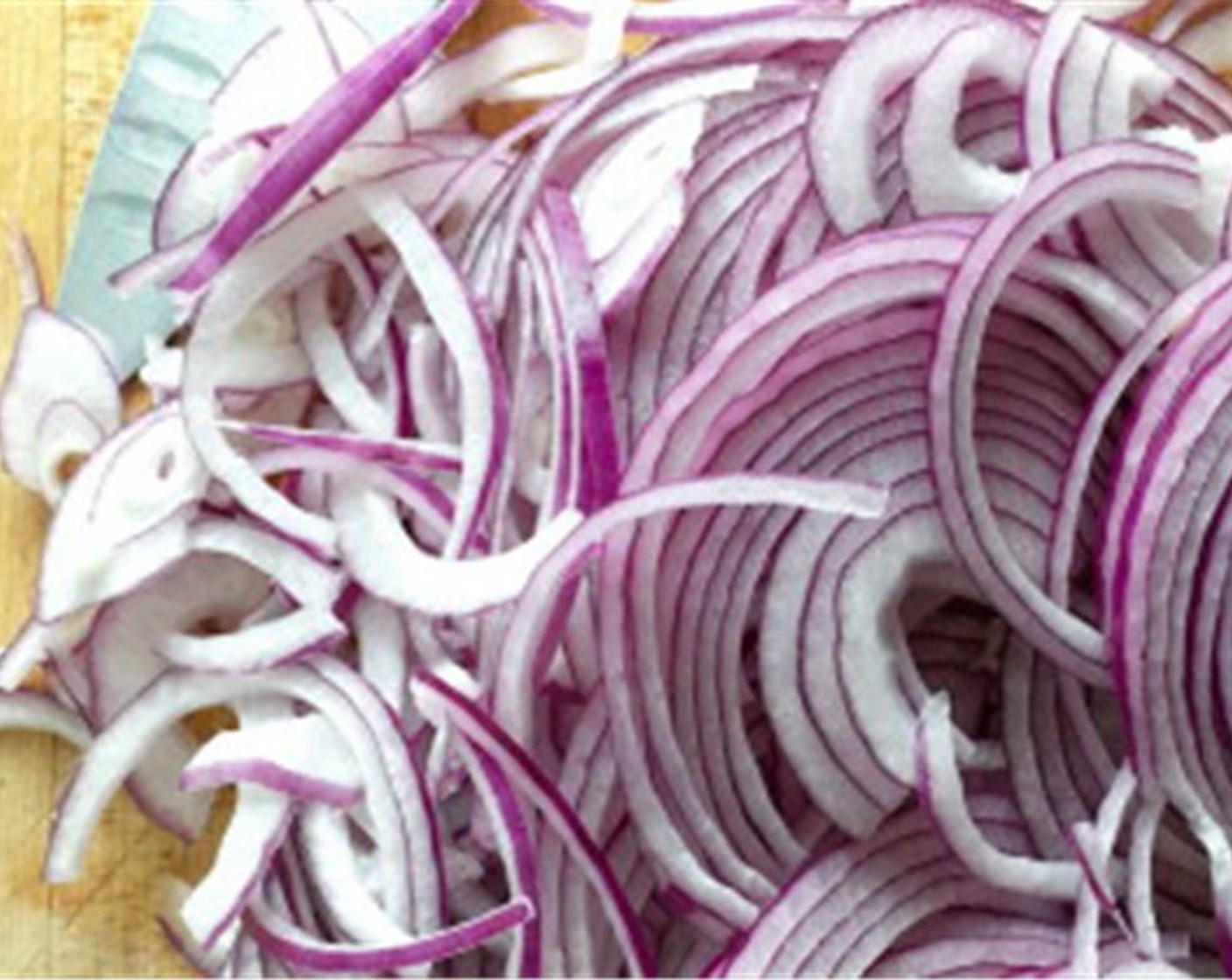 step 2 For balsamic onions, begin by thinly slicing the Red Onions (2). In a hot pan, add Olive Oil (2 Tbsp) and cook the onions over a medium-high flame until they begin to brown a bit. Add Granulated Sugar (1 Tbsp), Salt (to taste), and Ground Black Pepper (to taste) and turn the heat down to medium.