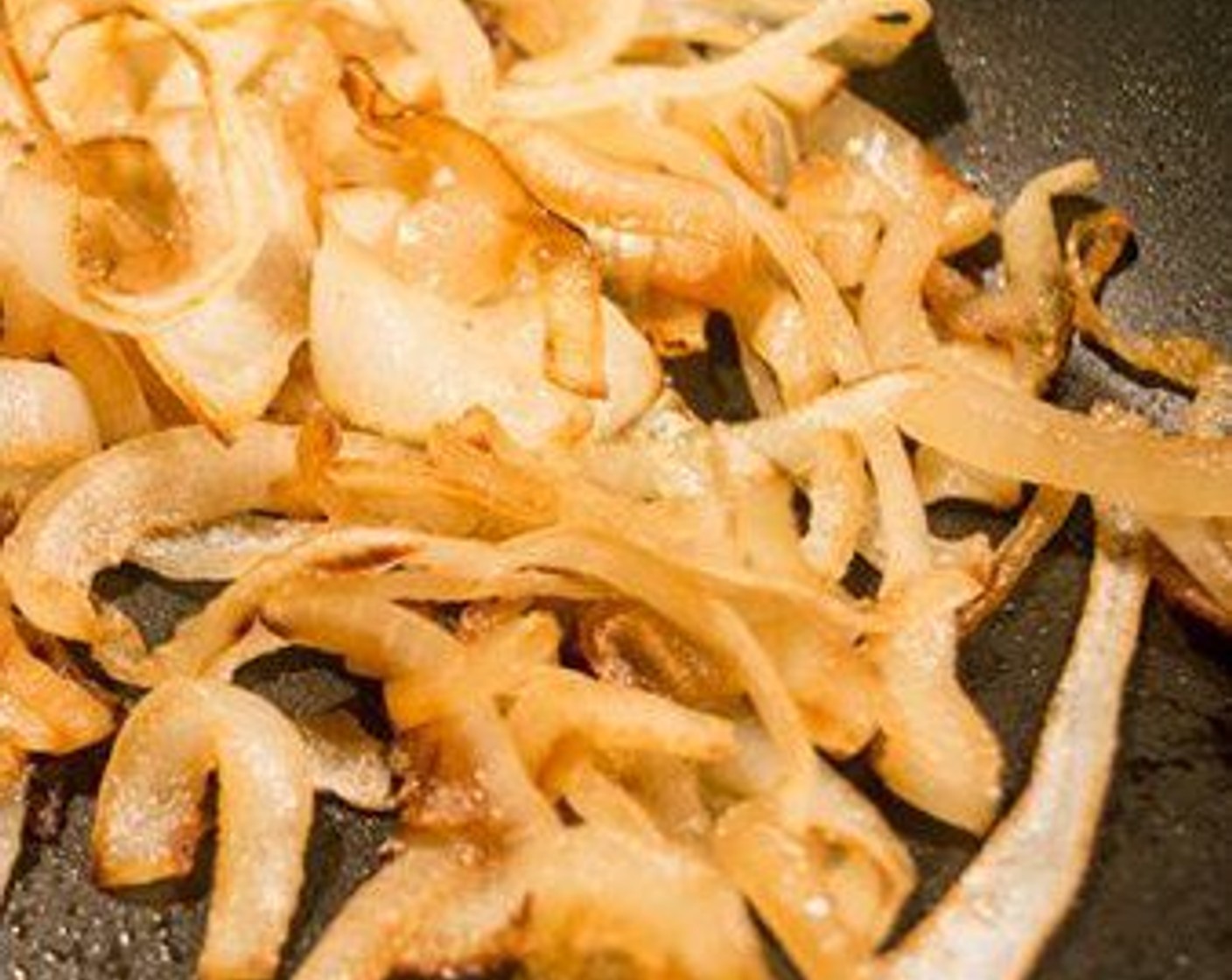 step 8 For the Onions: While the fries cook, caramelize the Onion (1). Heat skillet, coat bottom of the pan with Coconut Oil Cooking Spray (as needed). Add onions and cook over medium-high heat, stirring frequently, for 10-15 minutes or until soft and caramelized. Set aside and keep warm.