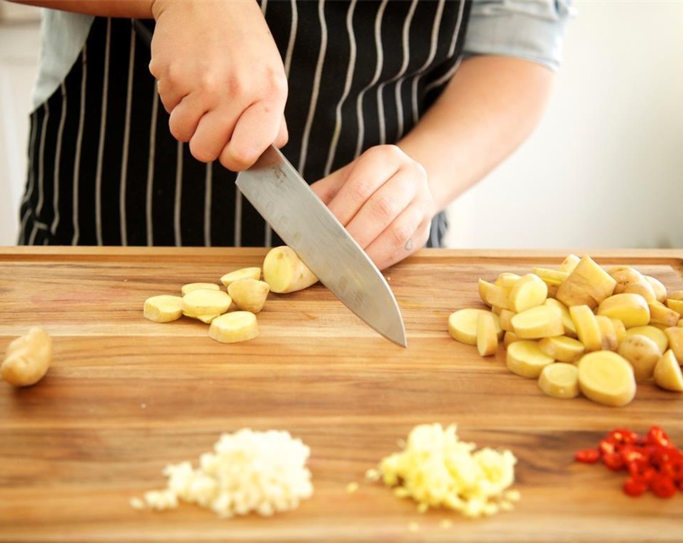 step 3 Peel the Fresh Ginger (1/3 cup). Mince the ginger and Garlic (6 cloves) and set aside. Cut Fingerling Potato (3/4 cup) into quarter inch slices and set aside. Reserve a few Fresh Cilantro (1 cup) leaves for garnish. Roughly chop remaining stems and leaves and set aside.