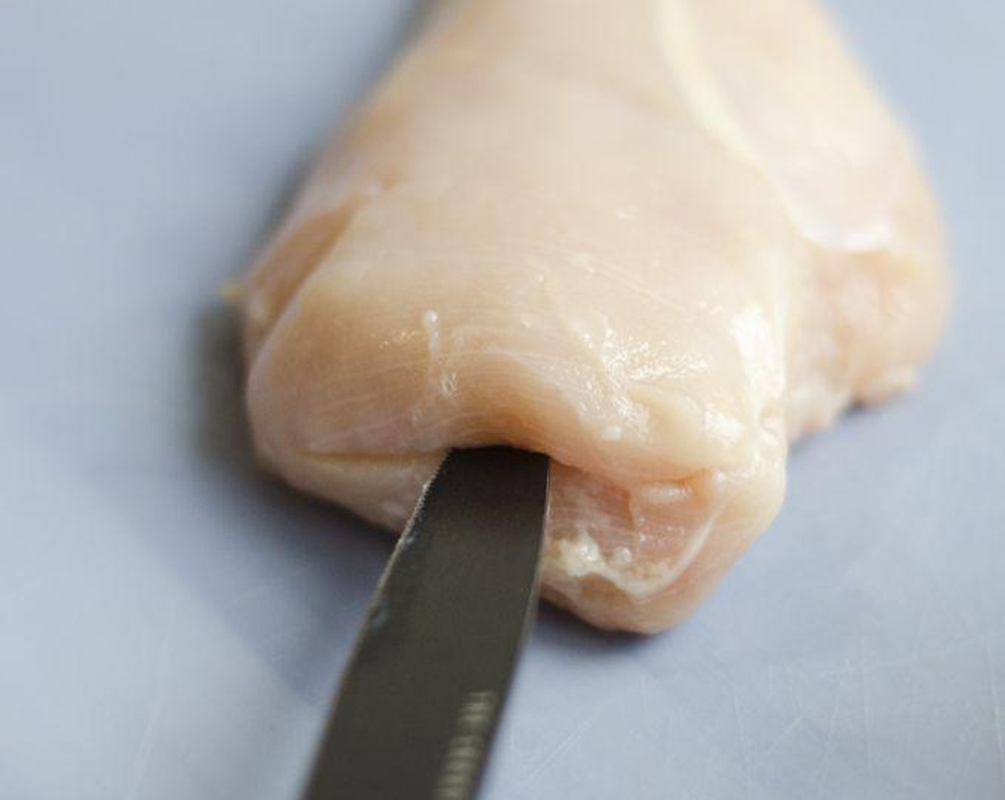 step 1 Place one Boneless, Skinless Chicken Breasts (4) on cutting board, with one hand on top of chicken, parallel to cutting board. Insert knife 4 inches into middle of breast widthwise, and make a 2-inch wide pocket. Repeat for each chicken breast.