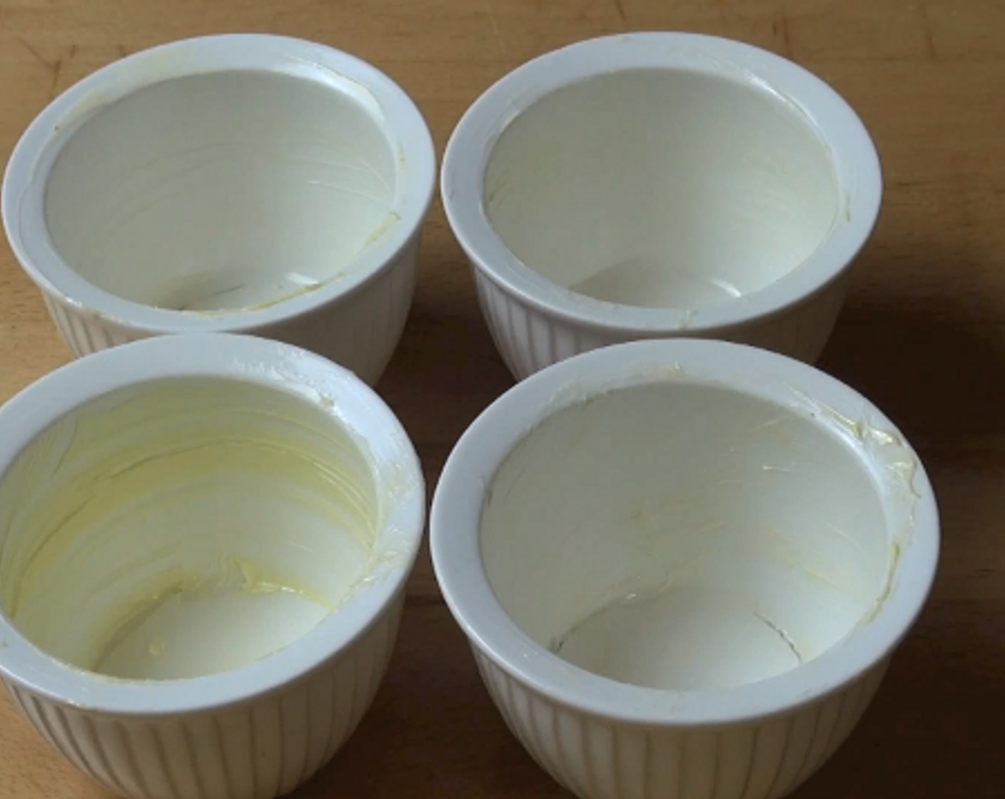 step 2 Grease four 200 milliliter pudding bowls with butter and place a small round of baking paper in the base of each one.