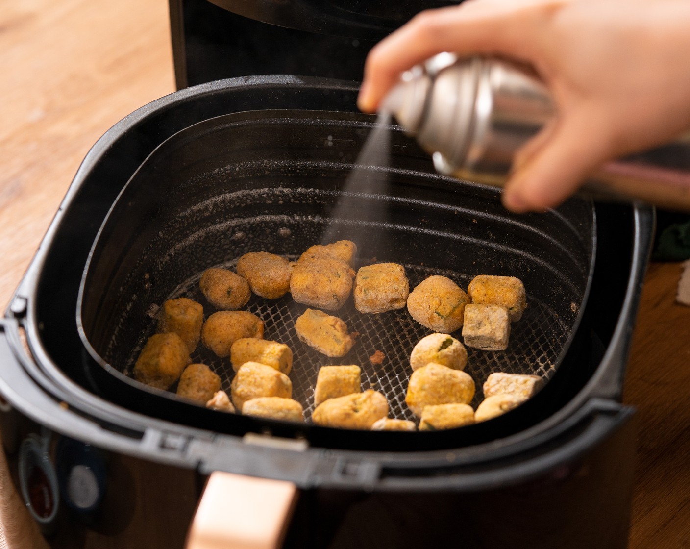 step 5 Place okra on the air fryer tray in a single layer. Spray the top with Non-Stick Baking Spray (as needed). Cook for about 5 minutes.