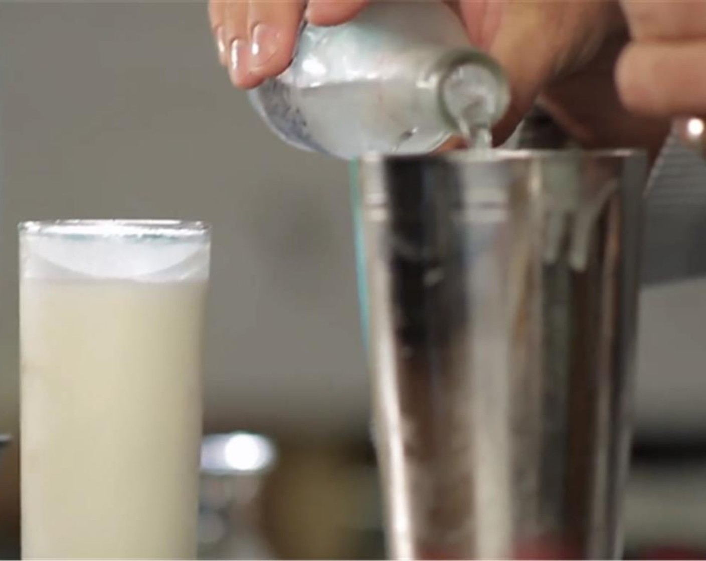 step 4 Pour the remaining Soda Water (2 fl oz) back into the cocktail shaker and gently swirl. Use the remaining froth to top the drink.