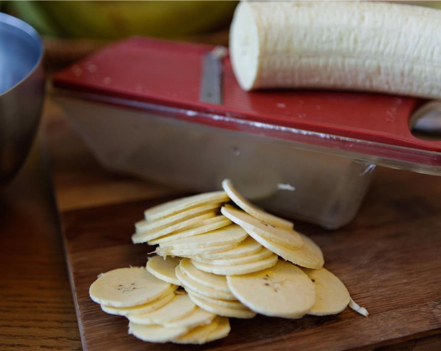 step 5 Using a mandoline, slice the plantain thinly.