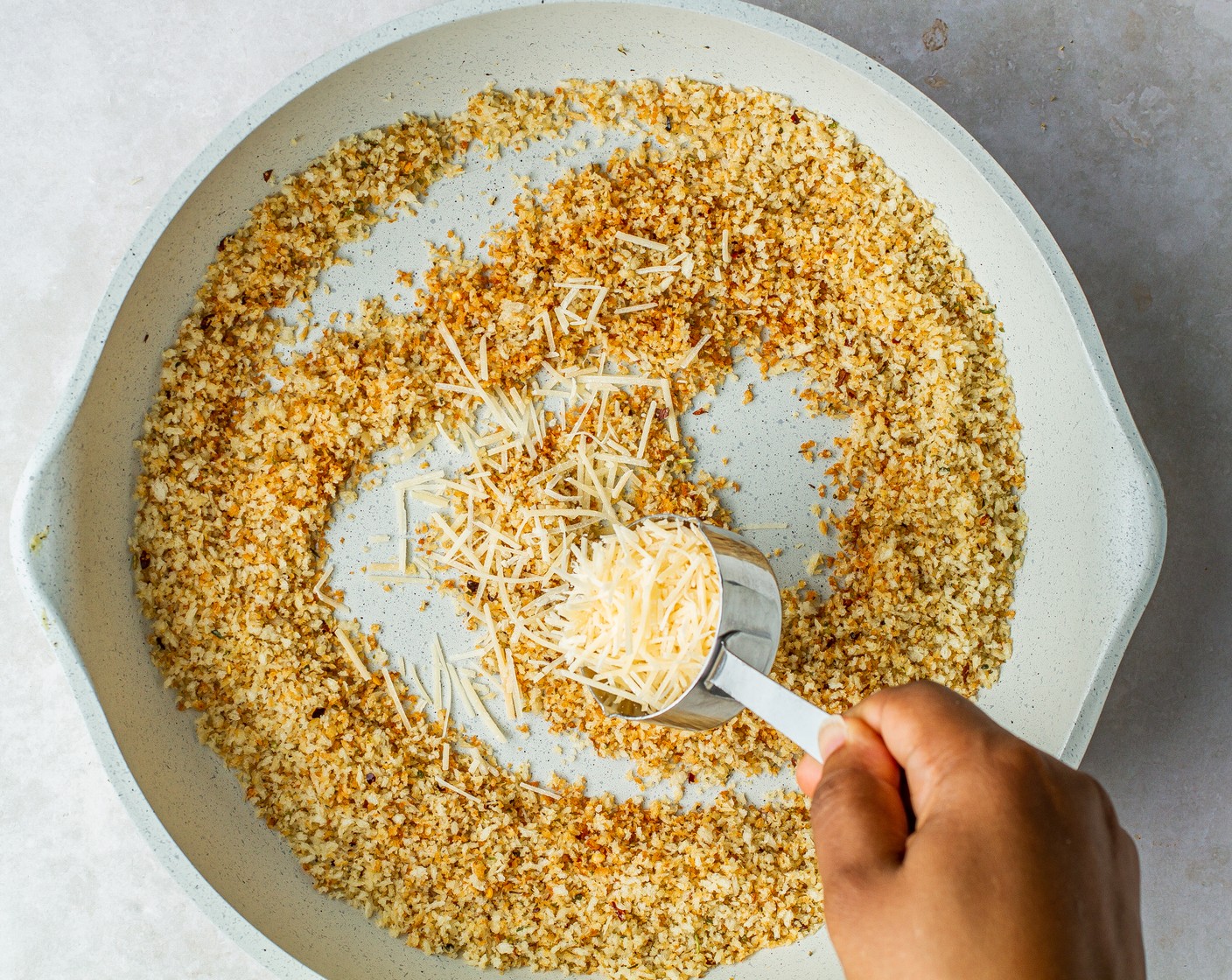 step 2 Remove from the heat and stir in Shredded Parmesan Cheese (1/4 cup). Transfer toasted breadcrumbs to another vessel and set aside.