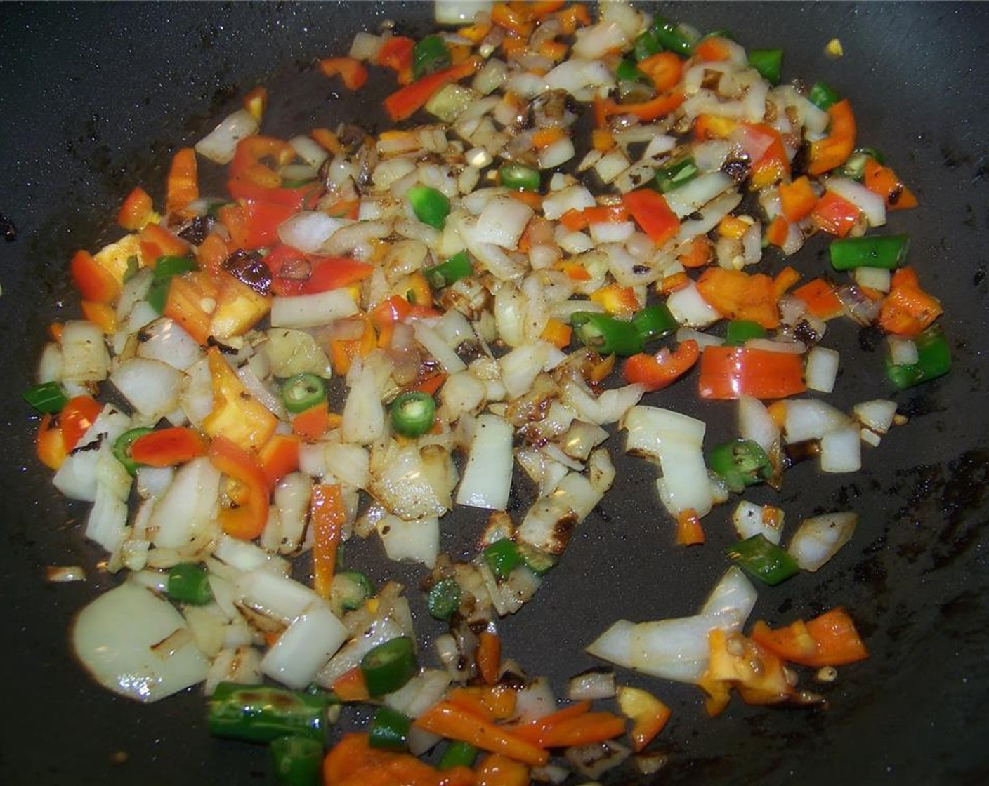 step 6 In the pan drippings, saute Garlic (2 cloves), Bell Pepper (1/2), Jalapeño Pepper (1), and Onion (1/2) for a few minutes on medium high heat.