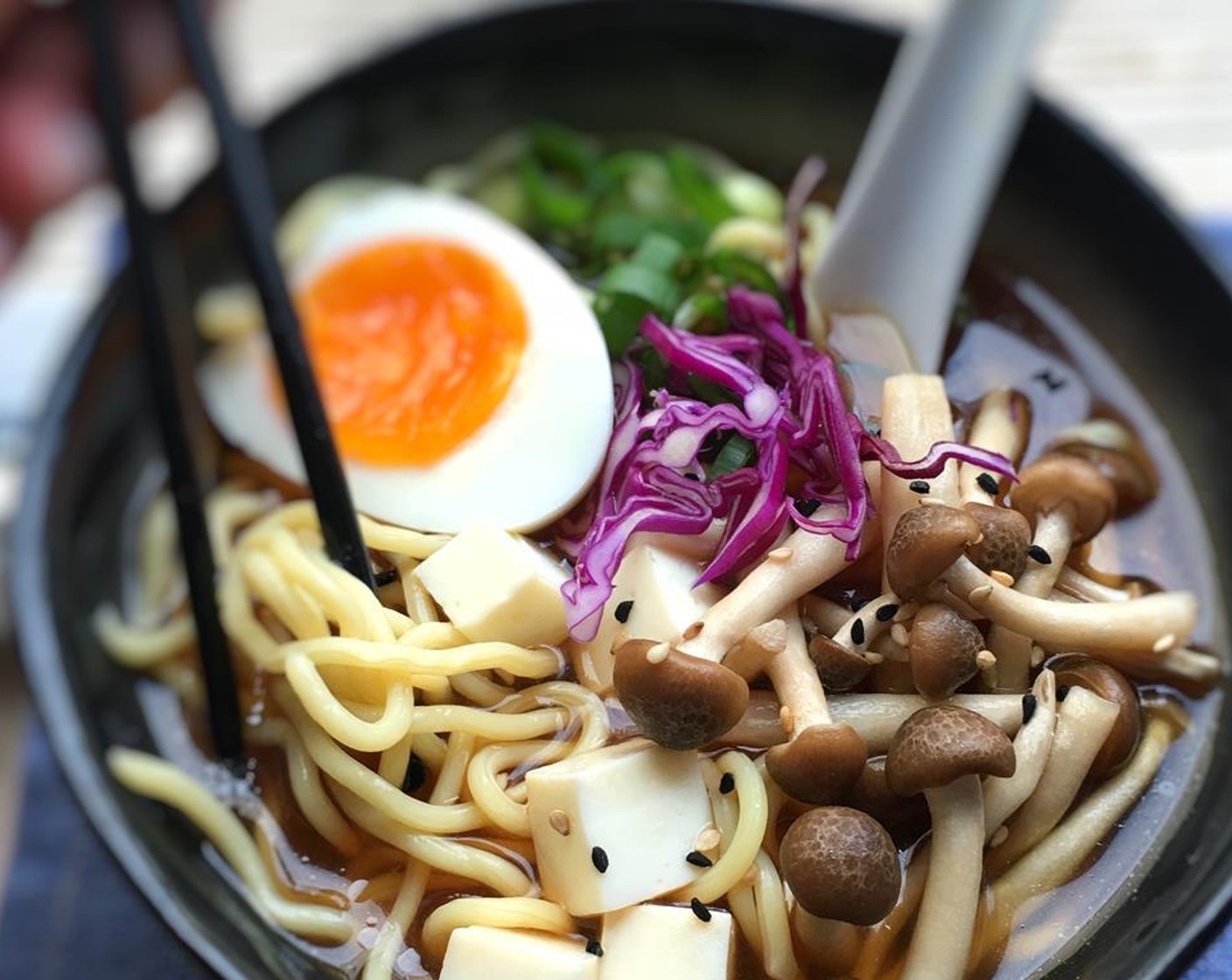 step 8 Divide the noodles, tofu, mushrooms and miso soup over 2 large bowls. Garnish with the eggs, the sliced Green Cabbage (2 Tbsp), the spring Scallion (1 bunch) and a sprinkle of Sesame Seeds (1 tsp). Serve warm and enjoy.