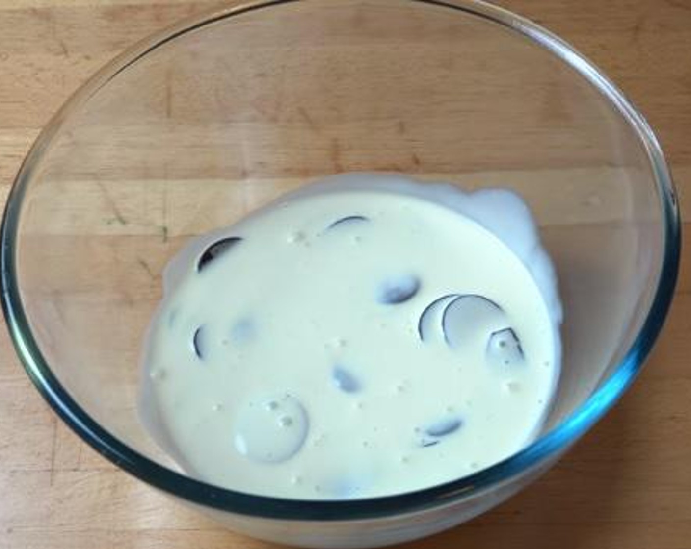 step 1 In a large glass bowl, add half of the Kemps Heavy Whipping Cream (2 cups) and Dark Chocolate (1 cup). Give the mixture a gentle stir.