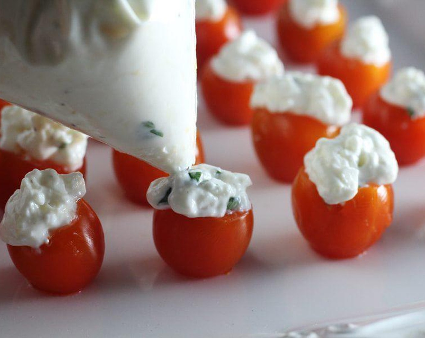 step 5 Spoon the cheese filling evenly into each prepared tomato.