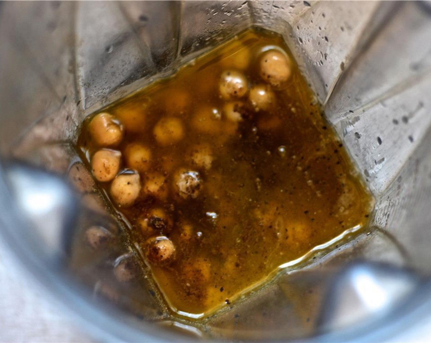 step 1 Add Chickpeas (1 can), Tahini (1/3 cup), Extra-Virgin Olive Oil (4 Tbsp), juice from Lemons (1 1/4), Garlic (2 cloves), Ground Cumin (1/2 tsp), Salt (1/2 tsp) and Freshly Ground Black Pepper (1/2 tsp) in a food processor or high speed blender.