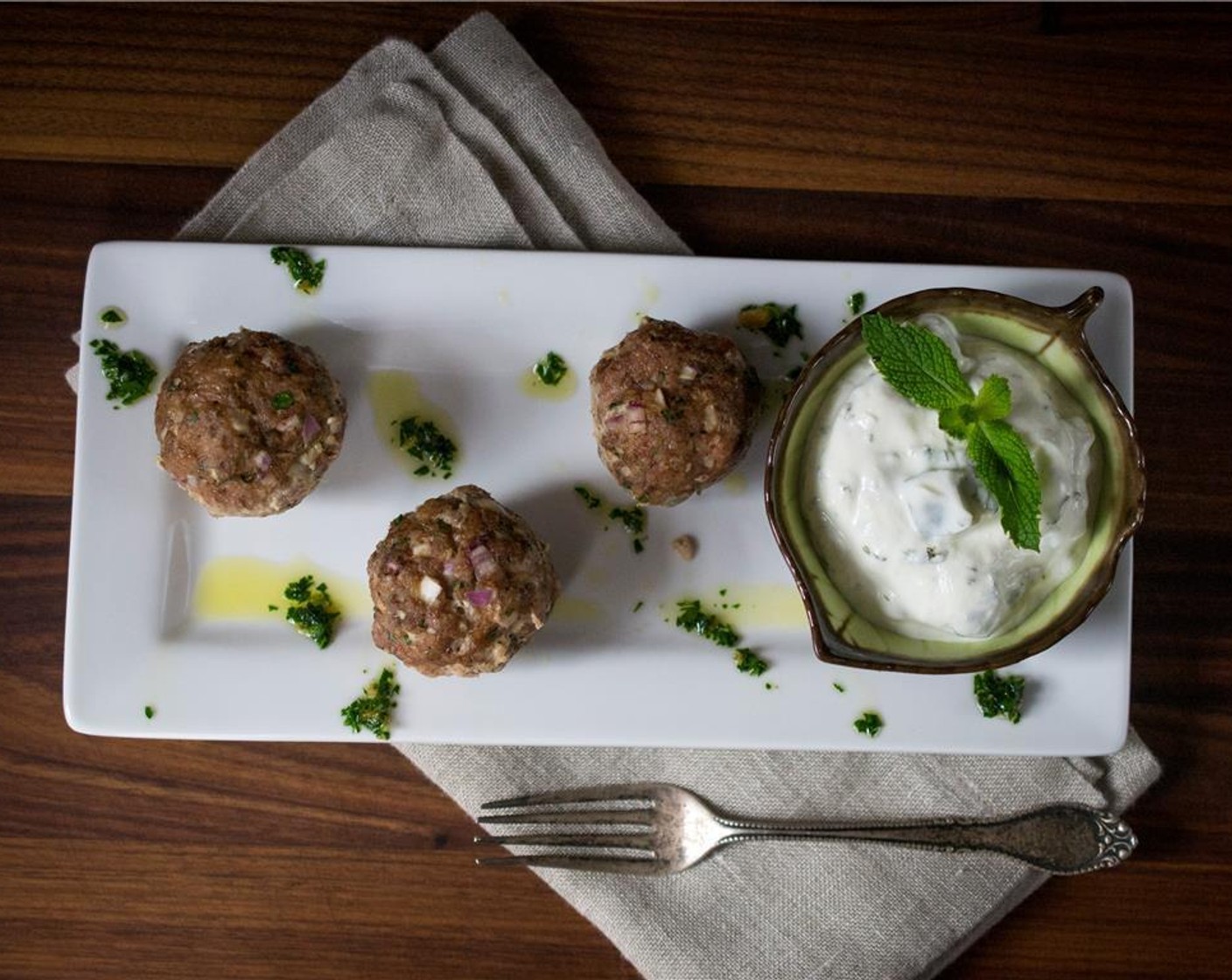 step 5 Serve meatballs immediately and drizzle with parsley chili oil. Top with Tzatziki (to taste)