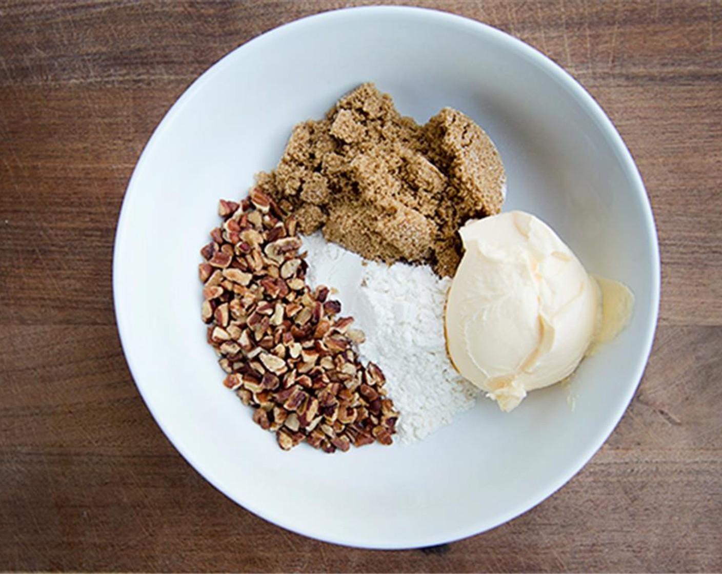 step 7 In a medium bowl, mix All-Purpose Flour (4 Tbsp), Brown Sugar (4 Tbsp), Butter (1/2 tsp), Chopped Pecans (4 Tbsp).