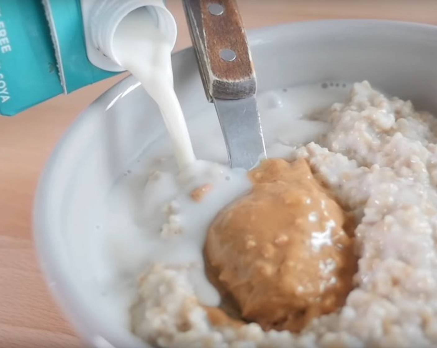 step 2 Pour cooked oats into a bowl and top with Almond Milk (4 Tbsp), if desired.
