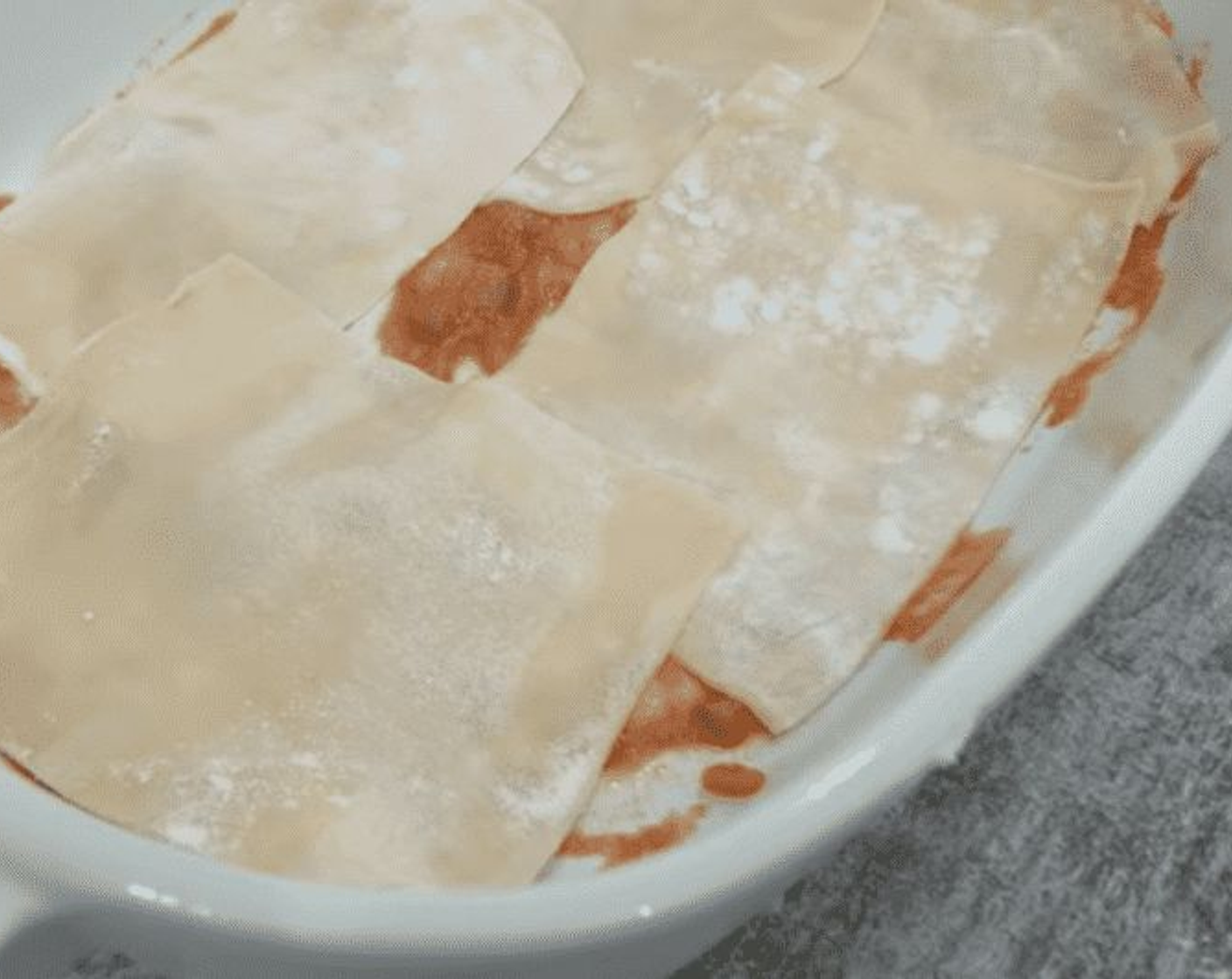 step 16 In a non-stick baking dish, line the base with a touch of sauce. Add layers of fresh Lasagna Sheets (10.5 oz), completely covering the base and not leaving any gaps.