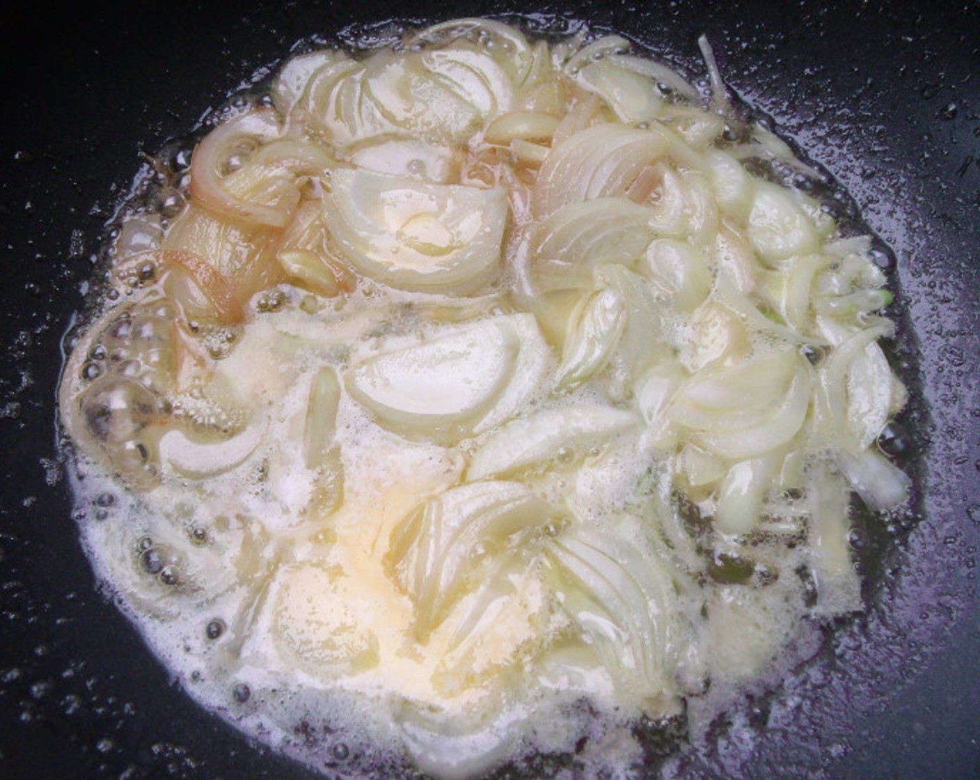 step 8 While the pork and the potatoes are cooking, saute Onion (1 cup) in Butter (1/3 cup) and Olive Oil (3 fl oz) until translucent.