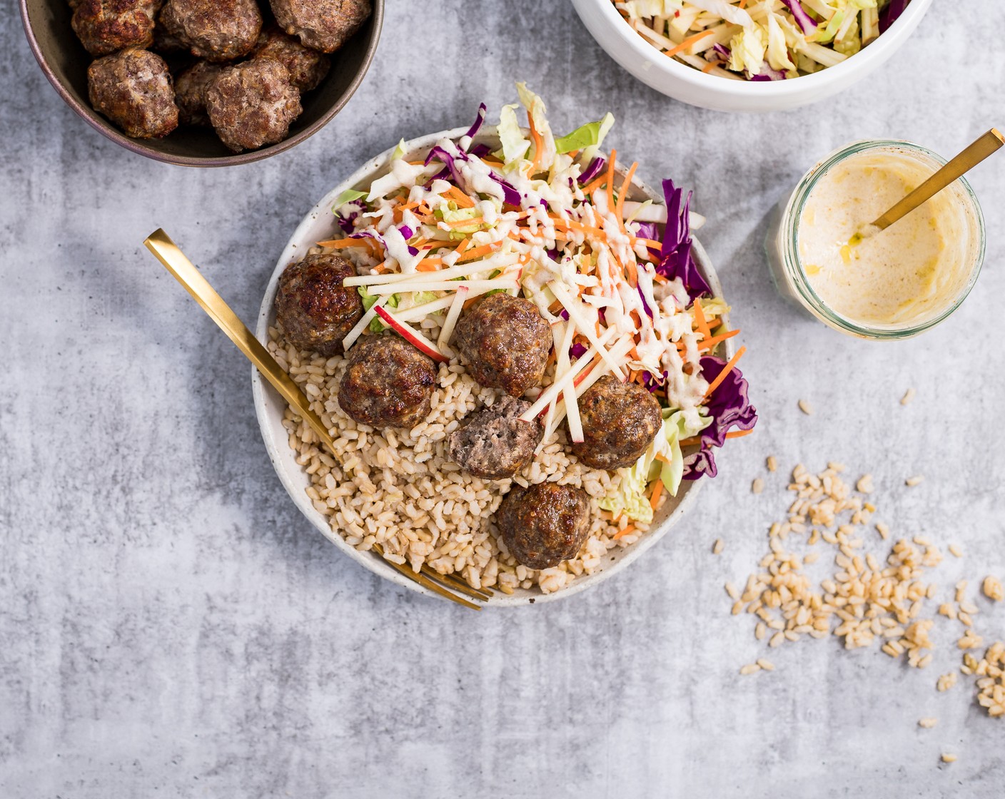 step 7 Assemble by dividing the hot rice between 4 bowls and topping with the rainbow slaw and meatballs. Drizzle dressing over the slaw and serve immediately.