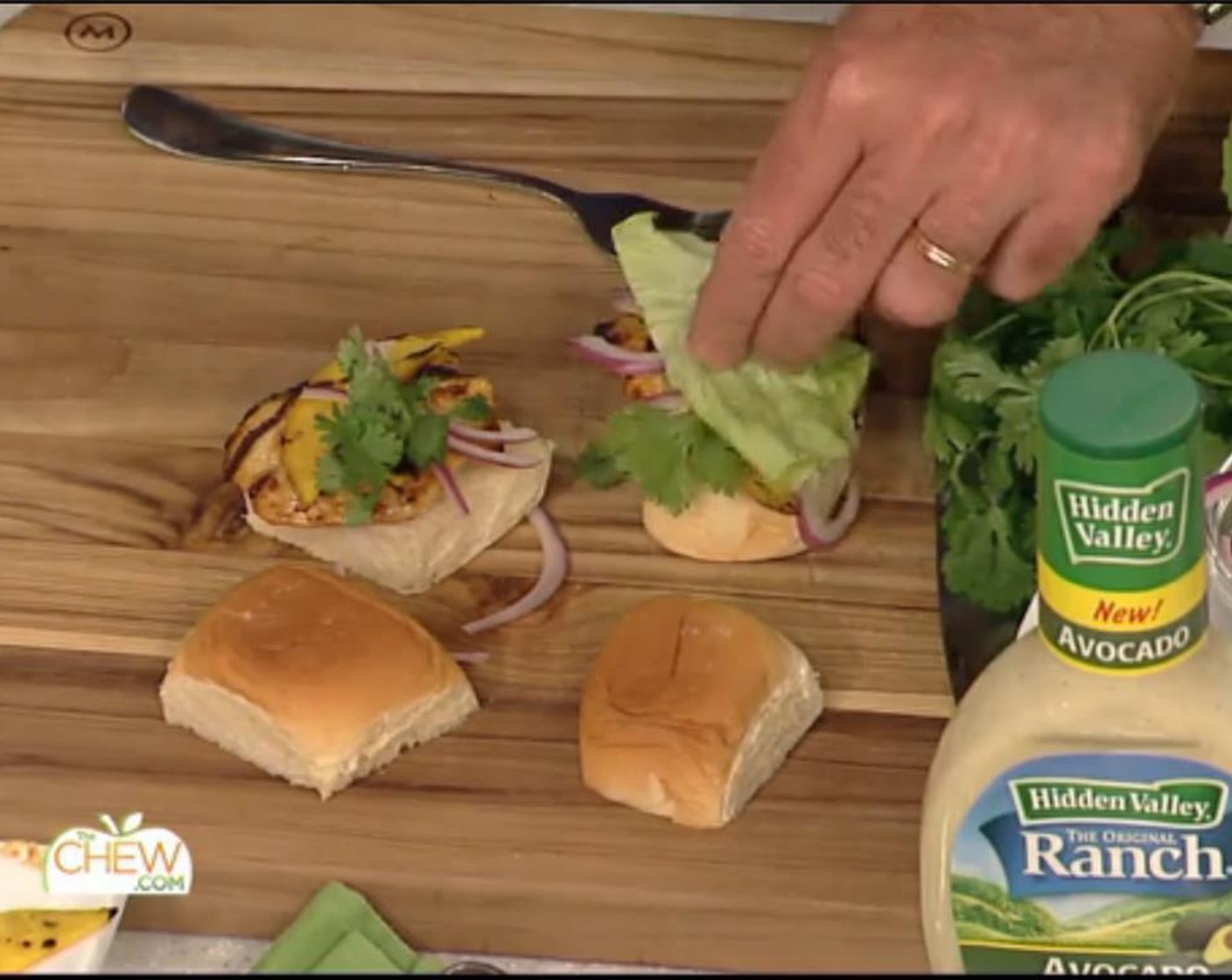 step 7 To build the sliders, cut the chicken to fit the roll and place on the bottom half of the Hawaiian Rolls (12). Top with 2 grilled mango slices and a few slices of red onion, some cilantro and a piece of Bibb Lettuce (1 head).