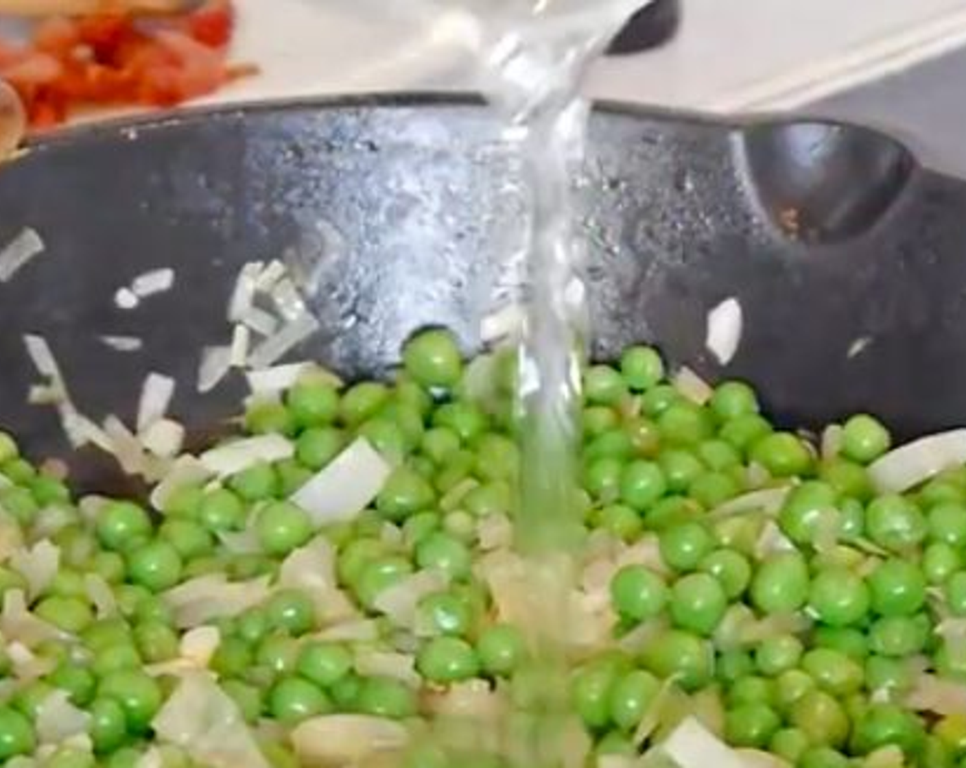 step 5 Then add the Green Peas (1 2/3 cups), leaving 3 tbsp aside for later and a splash of water, leave to cook at a medium temperature. Then add the Red Chili Pepper (1/2) and chopped basil mix and continue to cook.