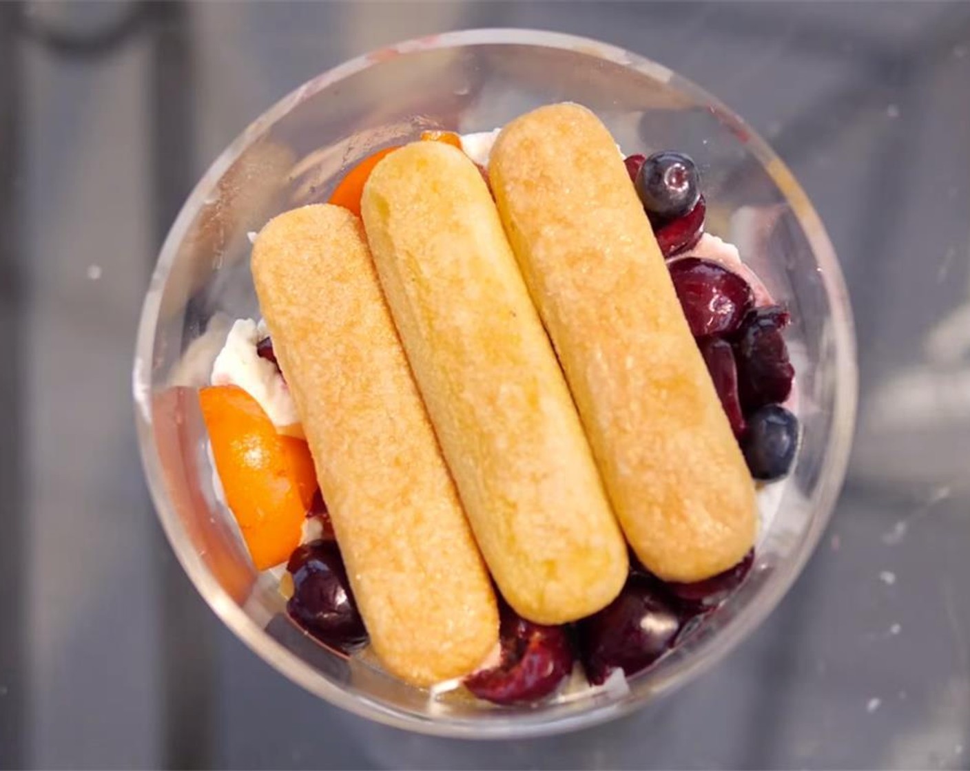 step 4 Top with a layer of cream, then a layer of fruit, before adding another layer of ladyfinger biscuits, and repeating.