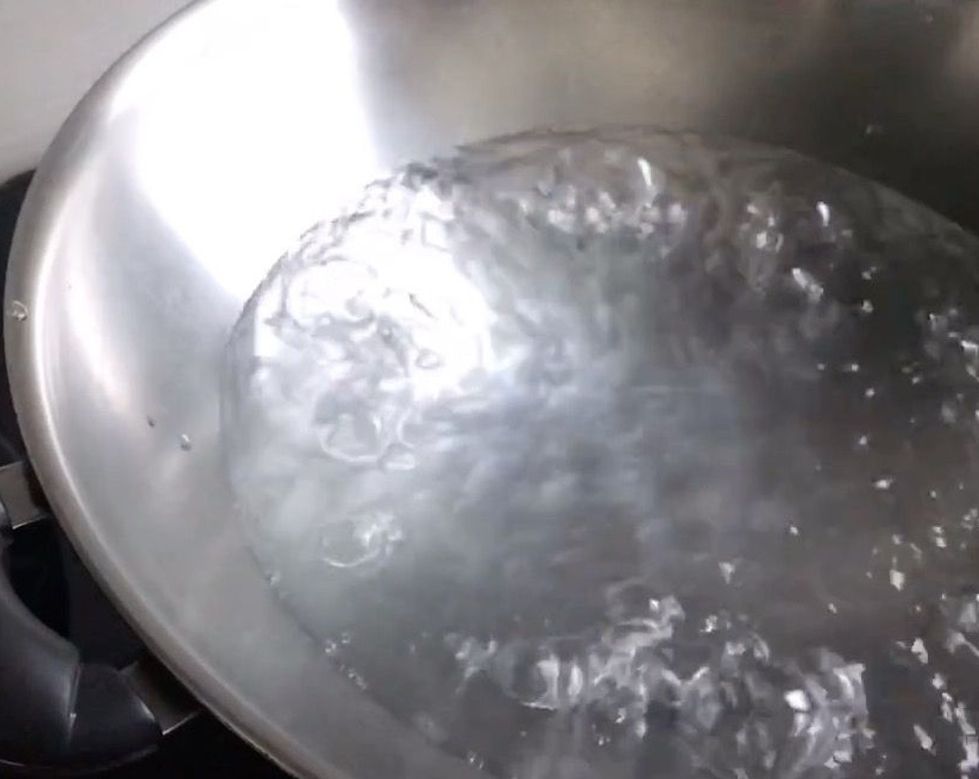 step 11 Meanwhile, prepare steamer to steam the muffins by boiling some water in a wok.