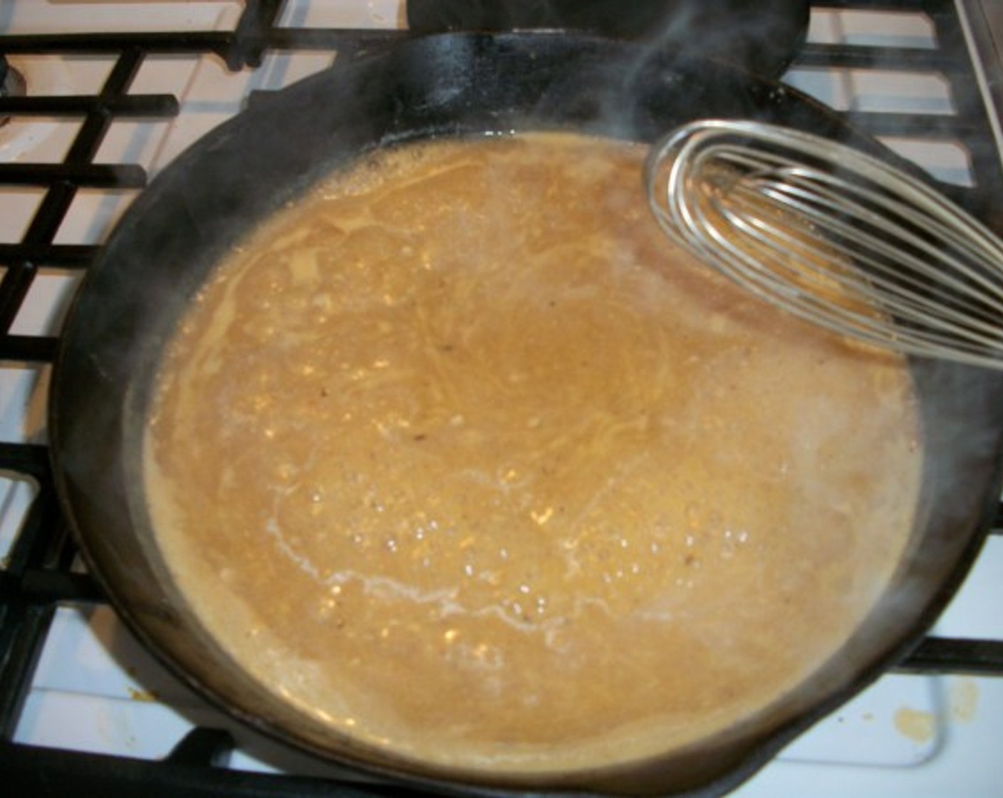 step 8 Gradually whisk in the Chicken Stock (10 fl oz). Simmer over low heat until gravy thickens. Whisk often.