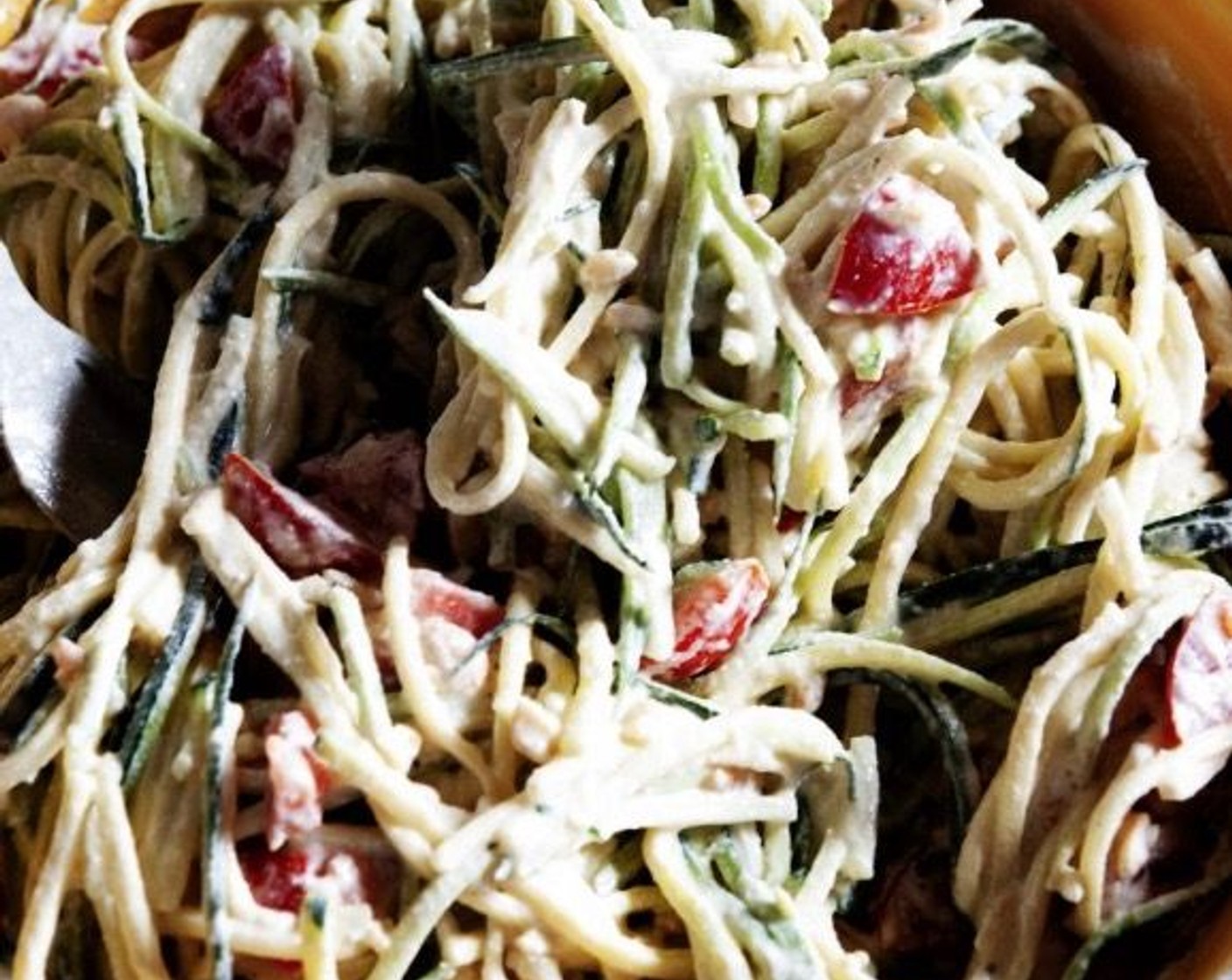 step 5 Place your zoodles into a large bowl and dress them with the sauce. Add the Cherry Tomatoes (8) and top it off with the chopped peanuts. Stir all the ingredients together.