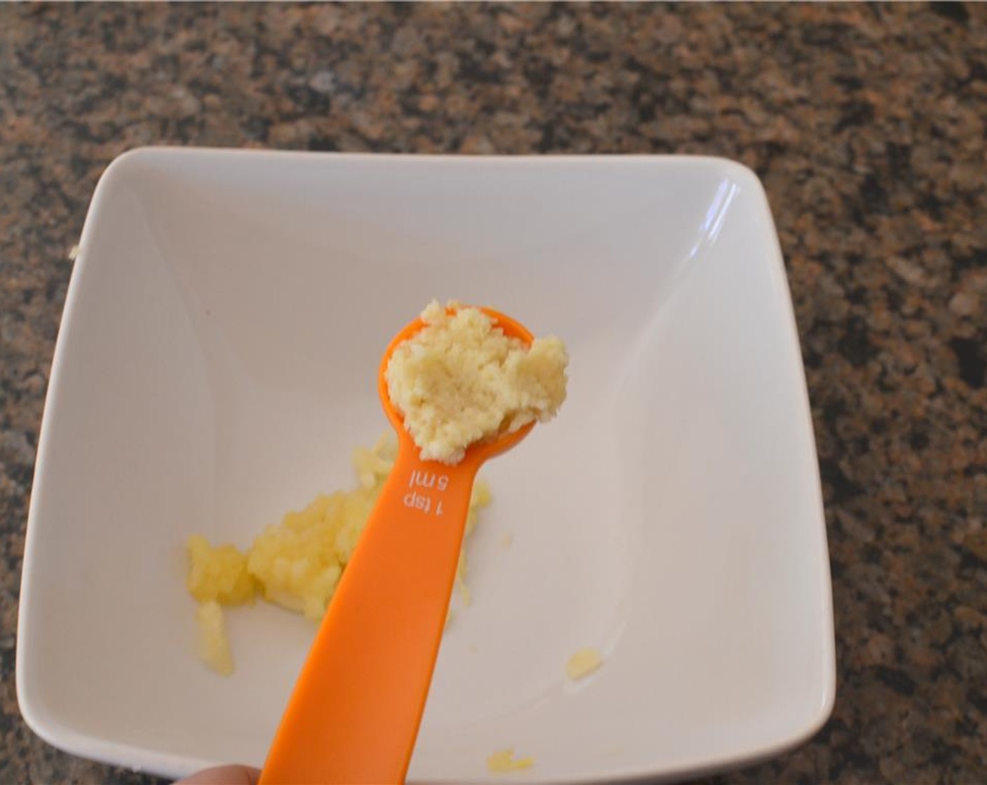 step 1 Peel and grate Garlic (4 cloves) and Fresh Ginger (1/2 Tbsp) into a small bowl.