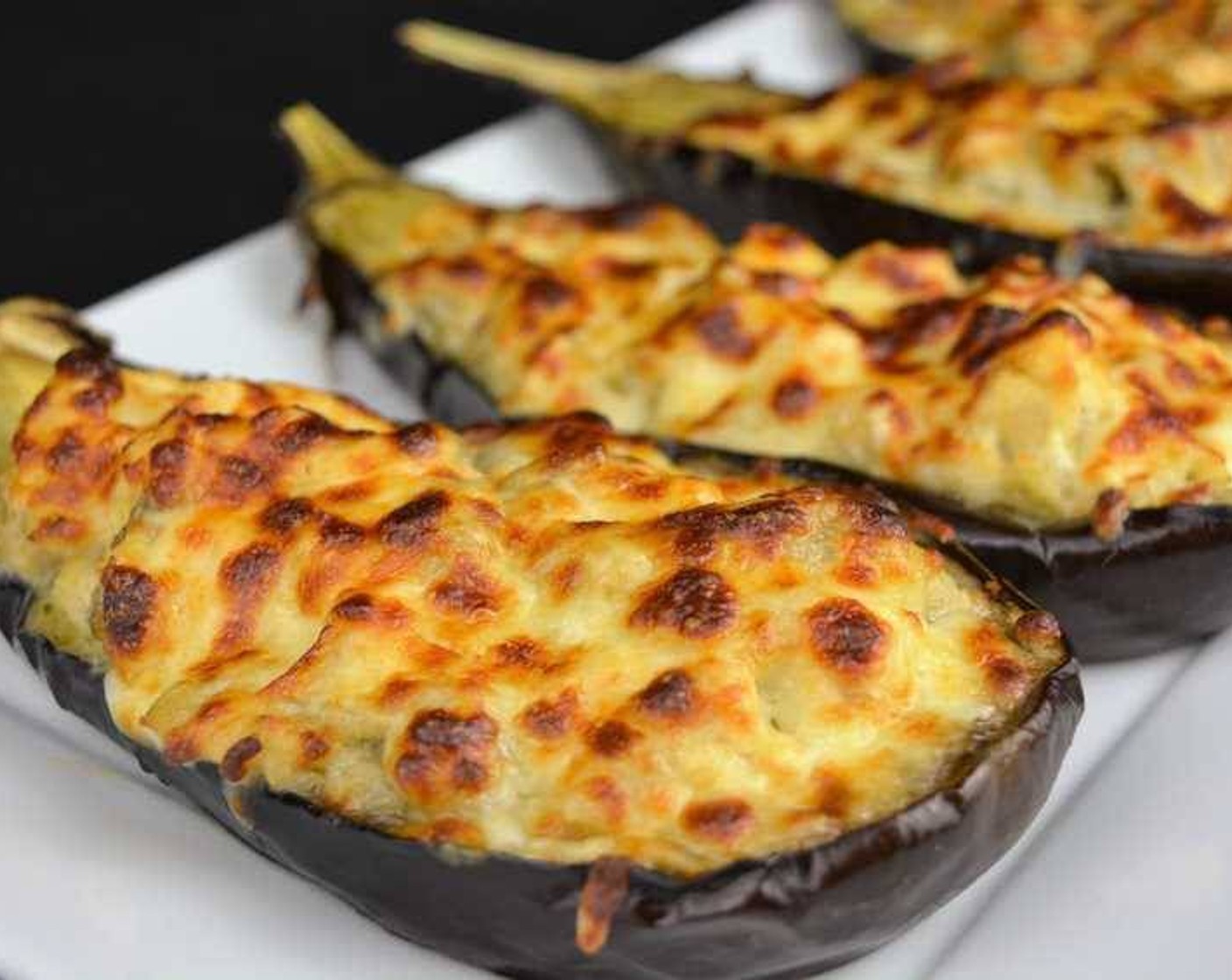 step 13 Once the shredded cheese has melted and has a golden brown color, remove the eggplants from the oven.