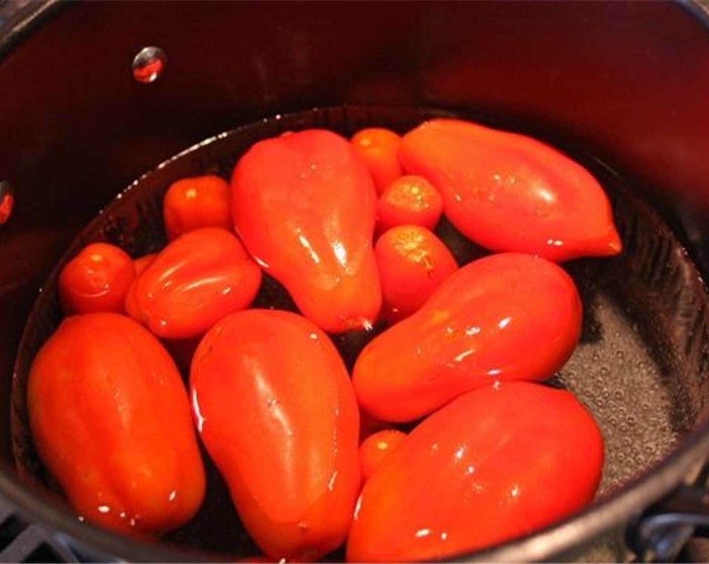 step 3 Place the tomatoes into the boiling water for 1-2 minutes. Smaller tomatoes will need less time, larger tomatoes will take longer.