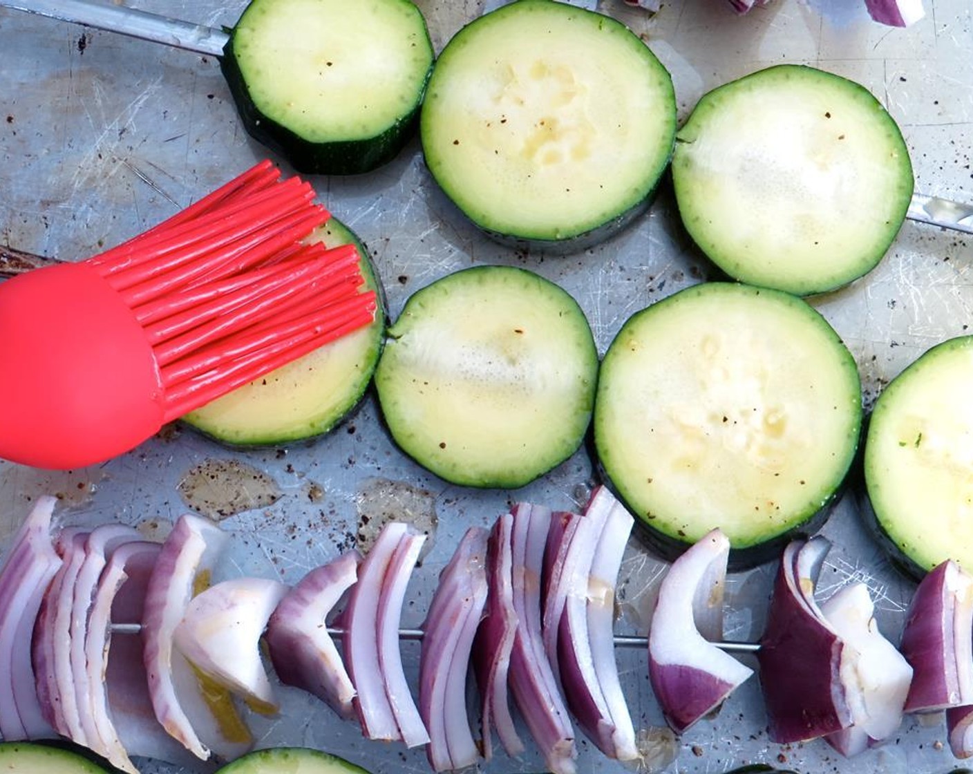 step 8 Brush 2 tablespoons of the olive oil over the onion and zucchini. Sprinkle both with Kosher Salt (to taste) and freshly ground Ground Black Pepper (to taste).