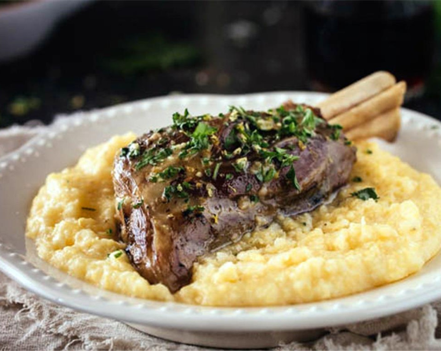 step 10 When ready to serve, garnish each lamb shanks with a tablespoon of gremolata and Parmesan Polenta (to taste).