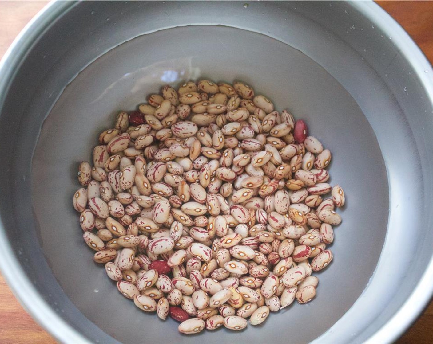 step 1 Pick through the Cranberry Beans (1 cup) to remove any pebbles or damaged beans. Soak the beans overnight in three times the amount of water to beans.