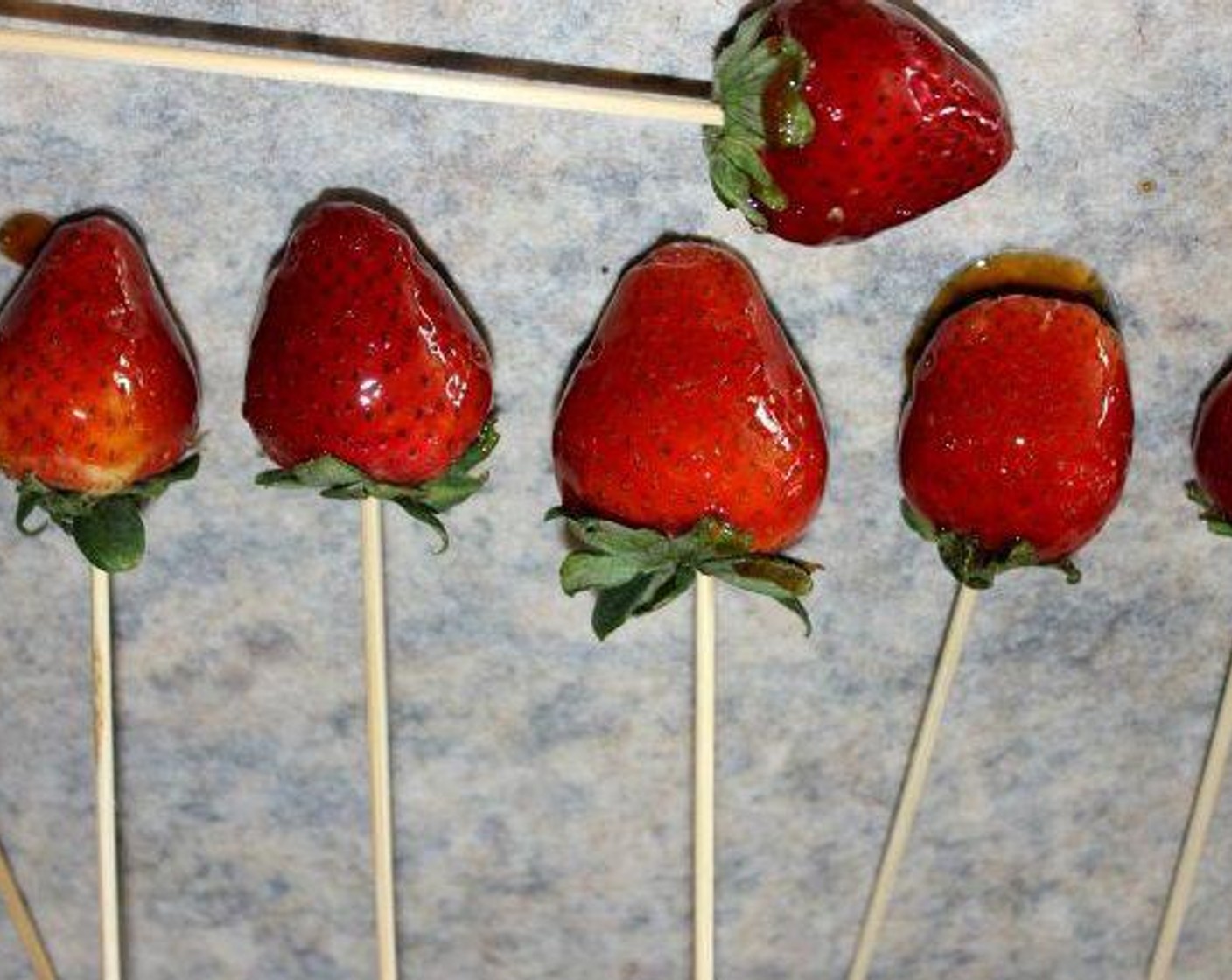 step 3 Take the hot sugar off of the heat. Roll each Strawberry around in the melted Sugar until it’s evenly coated. Set them onto wax paper to cool for about 15 minutes…