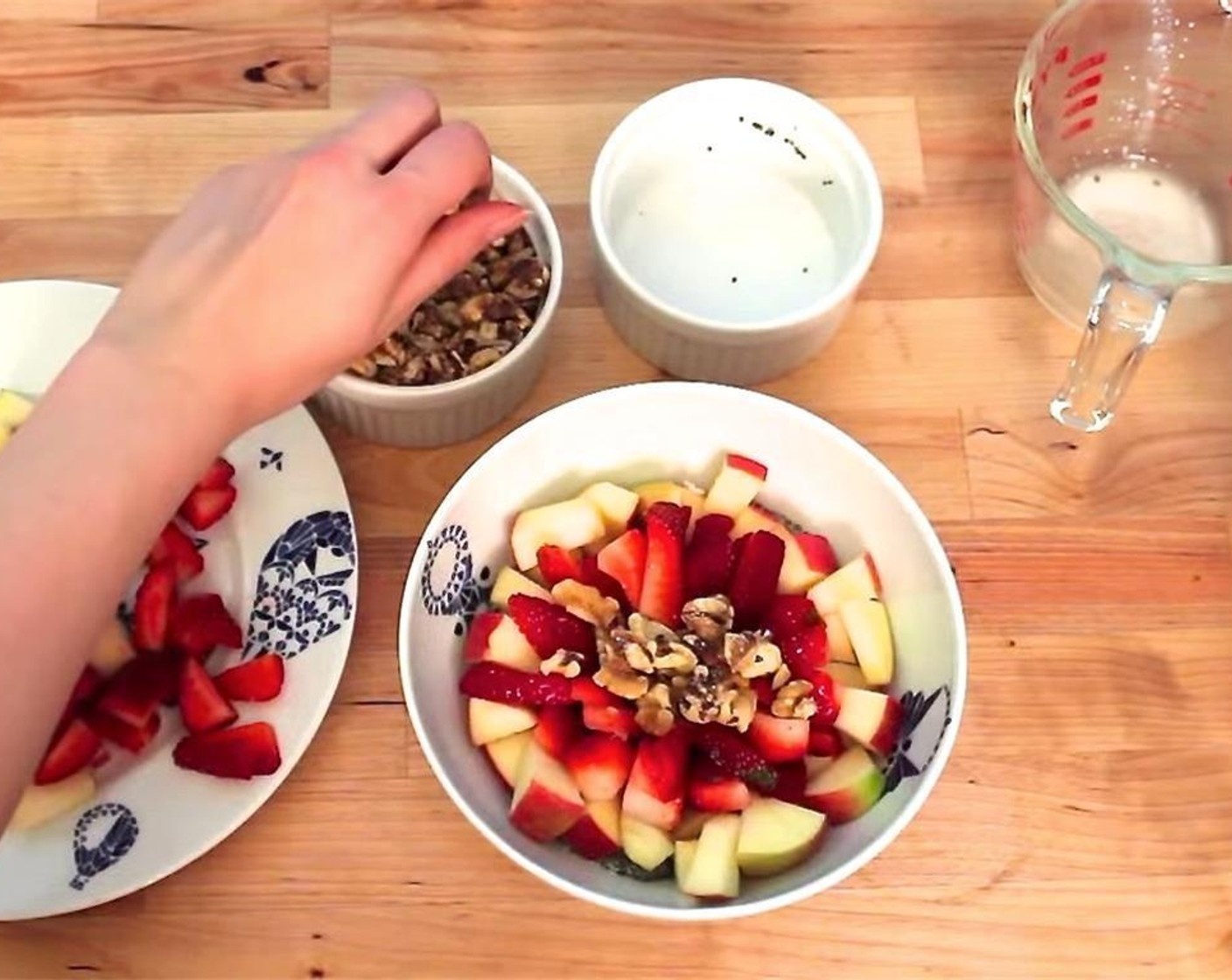 step 3 Chop the Apple (1) and Fresh Strawberries (2 cups). Set aside. Remove chia mixture from the fridge and divide it into four bowls. Top each bowl with the chopped Walnuts (to taste), apples, and strawberries.